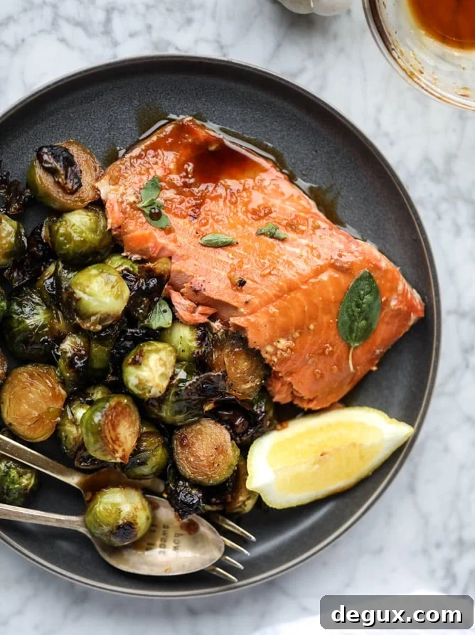 sheet pan honey garlic salmon and brussels I howsweeteats.com #sheetpan #salmon #honeygarlic #brusselssprouts