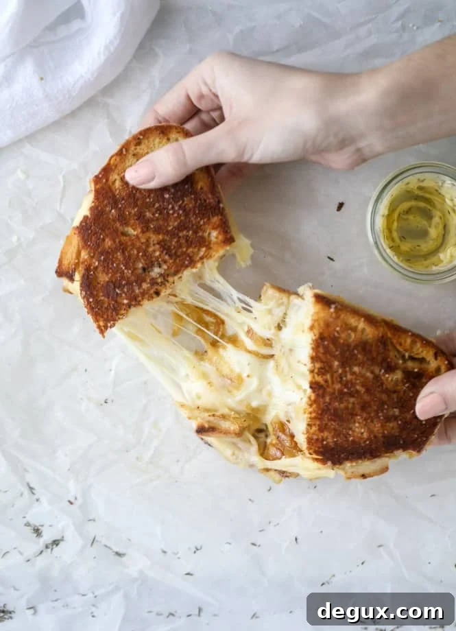 french onion grilled cheese with thyme butter I howsweeteats.com #grilledcheese #caramelizedonion #vegetarian