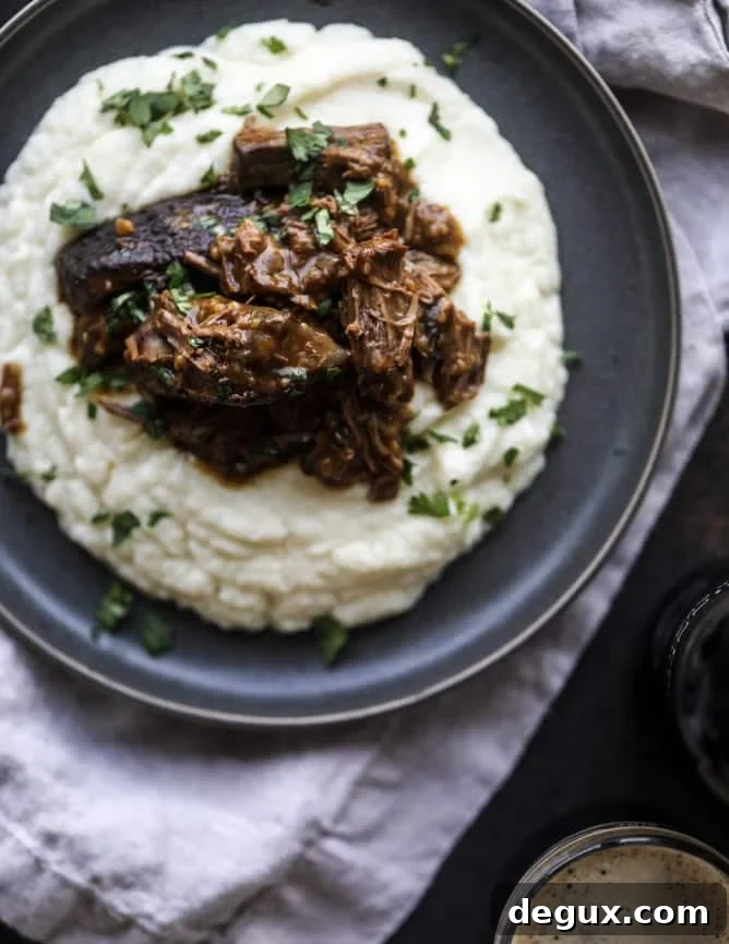 Guinness-Braised Short Ribs with Cheesy Cauliflower Mash 2 guinness short ribs with cheesy cauliflower mash I howsweeteats.com #slowcooker #guinness #shortribs #saintpatricksday #cauliflower