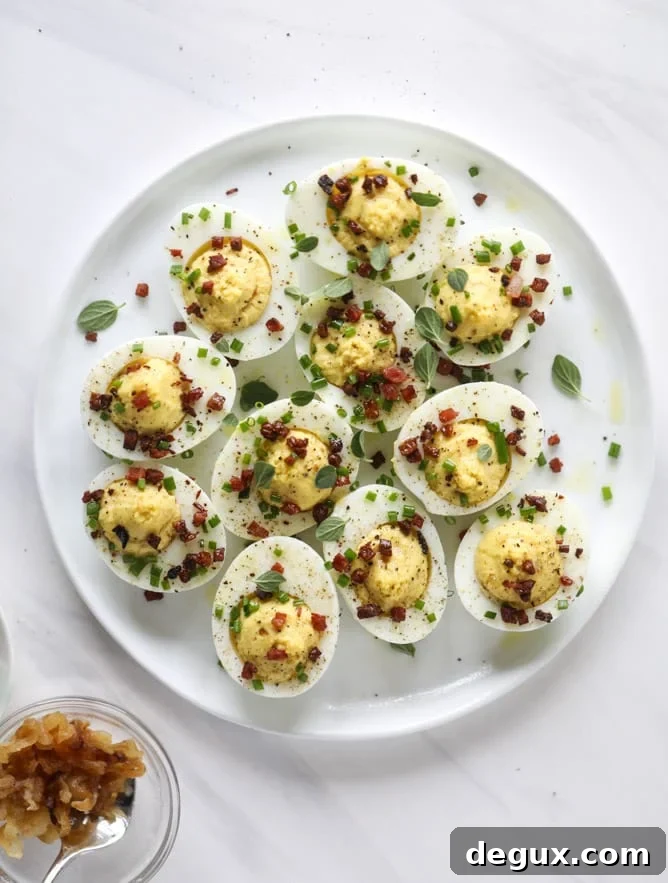 French Onion Deviled Eggs Recipe: Savory Appetizer with Caramelized Onions 2 french onion deviled eggs I howsweeteats.com #deviledeggs #frenchonion #easter #egg #recipes