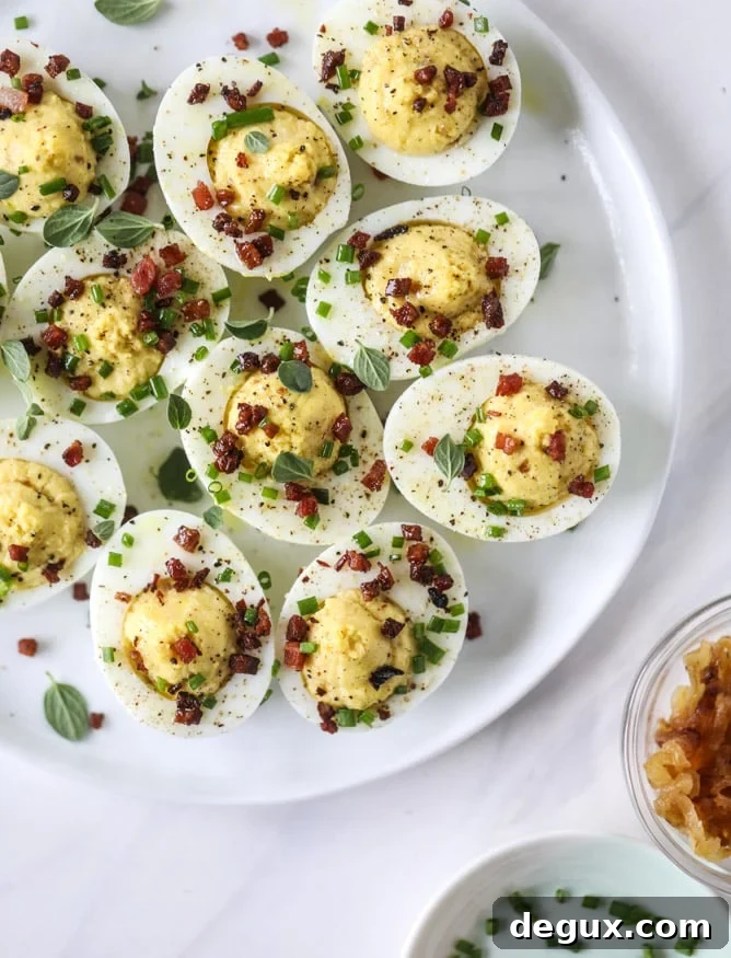 French Onion Deviled Eggs Recipe: Savory Appetizer with Caramelized Onions 8 french onion deviled eggs I howsweeteats.com #deviledeggs #frenchonion #easter #egg #recipes
