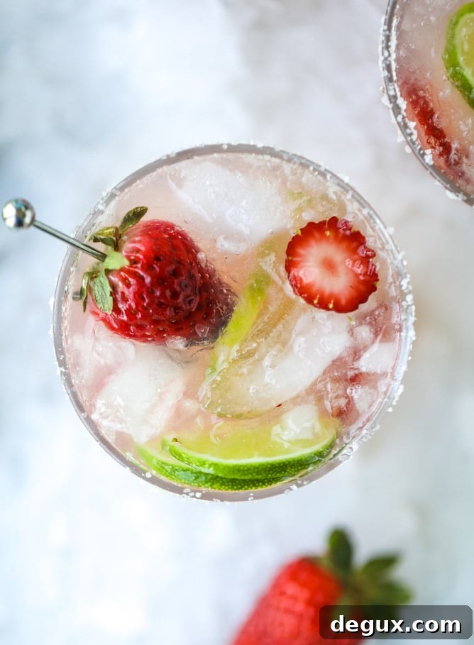 Smoked Strawberry Mezcal Margarita Recipe: Smoky Fruit Cocktail 4 smoked strawberry mezcal margaritas I howsweeteats.com #margaritas #mezcal #strawberry #lime