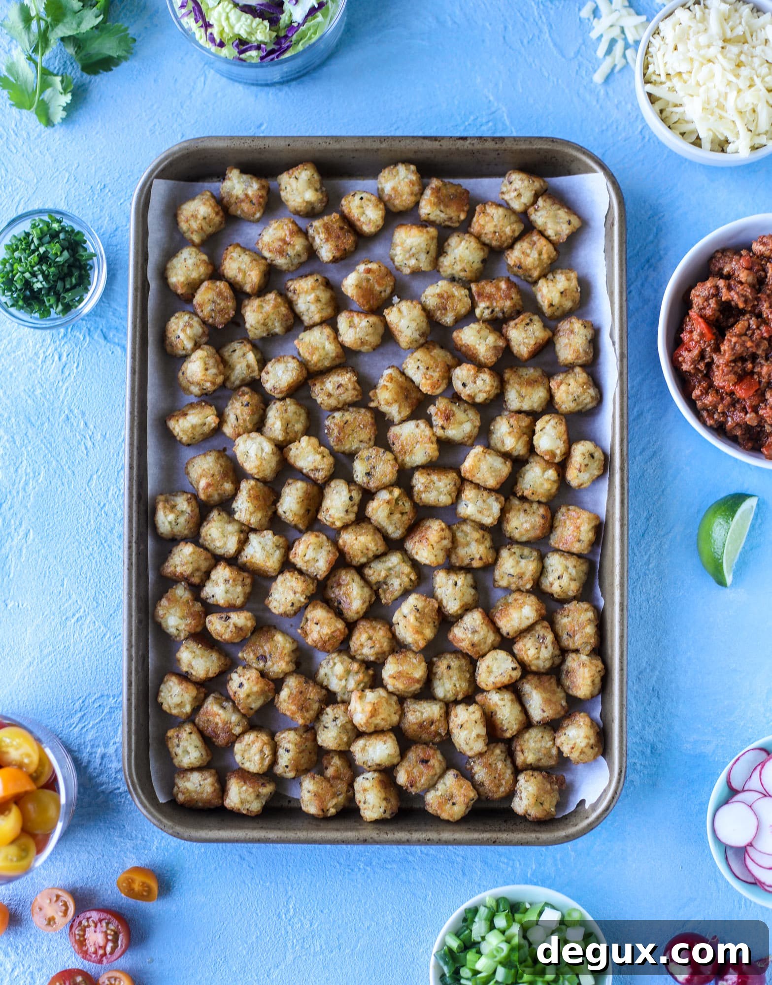 Sloppy Joe Totchos Sheet Pan Recipe for Game Day Snacks 3 These tater tot nachos, otherwise known as totchos, are so delicious! They are cheesy and topped with a tangy, homemade sloppy joe mixture. Melted cheese, fresh tomatoes, scallions and chives come together for the best party food. I howsweeteats.com #totchos #tater #tot #nachos #sloppy #joes