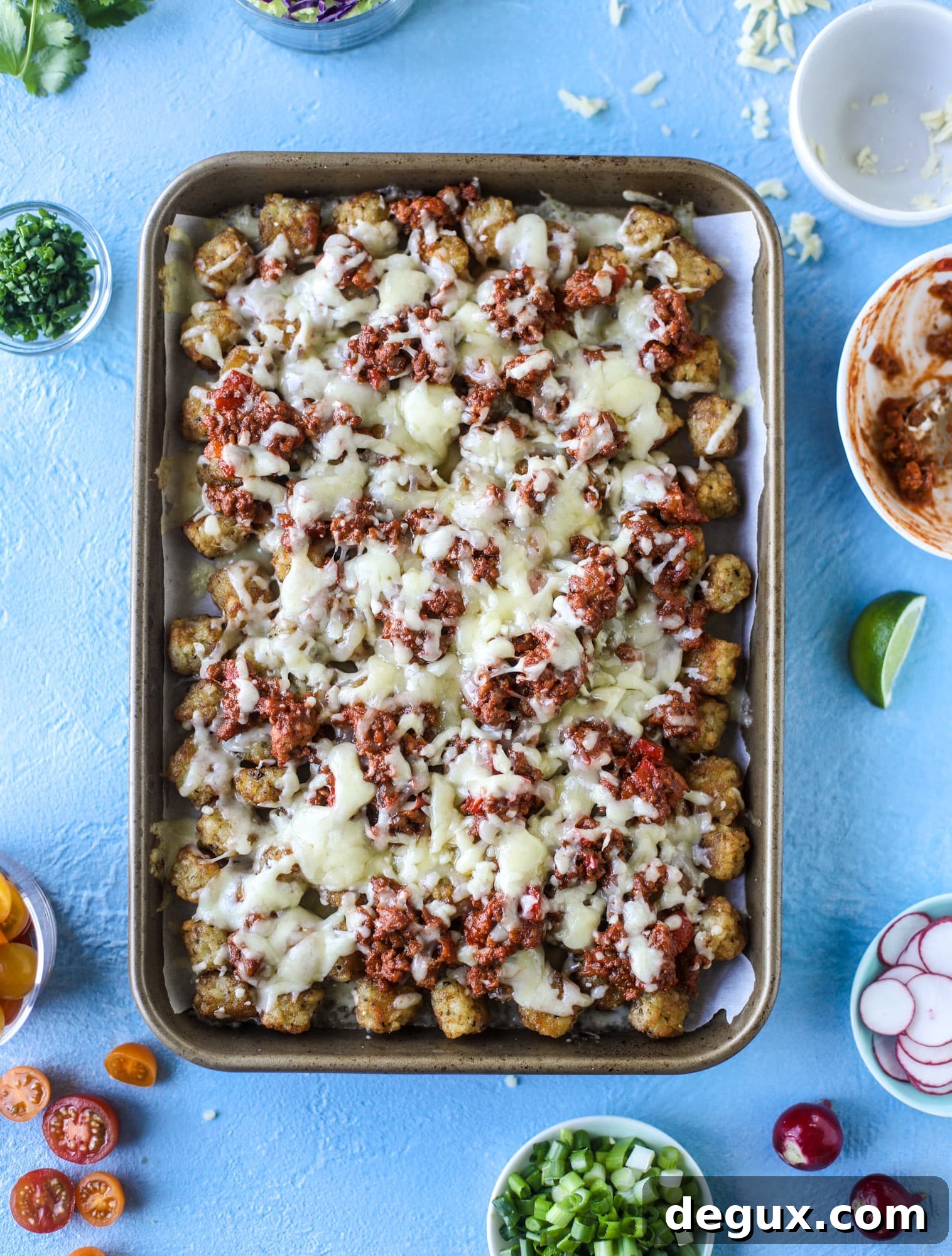 Sloppy Joe Totchos Sheet Pan Recipe for Game Day Snacks 4 These tater tot nachos, otherwise known as totchos, are so delicious! They are cheesy and topped with a tangy, homemade sloppy joe mixture. Melted cheese, fresh tomatoes, scallions and chives come together for the best party food. I howsweeteats.com #totchos #tater #tot #nachos #sloppy #joes