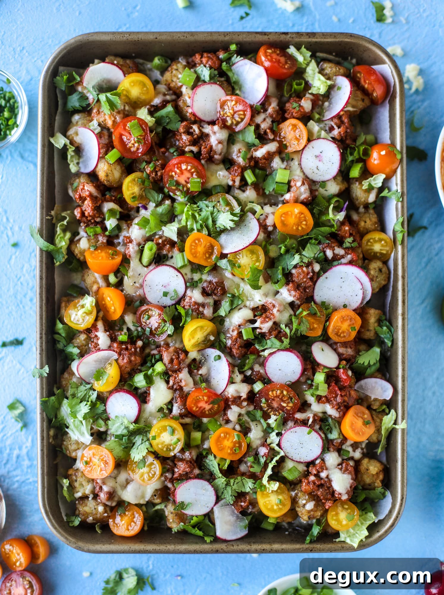 Sloppy Joe Totchos Sheet Pan Recipe for Game Day Snacks 5 These tater tot nachos, otherwise known as totchos, are so delicious! They are cheesy and topped with a tangy, homemade sloppy joe mixture. Melted cheese, fresh tomatoes, scallions and chives come together for the best party food. I howsweeteats.com #totchos #tater #tot #nachos #sloppy #joes