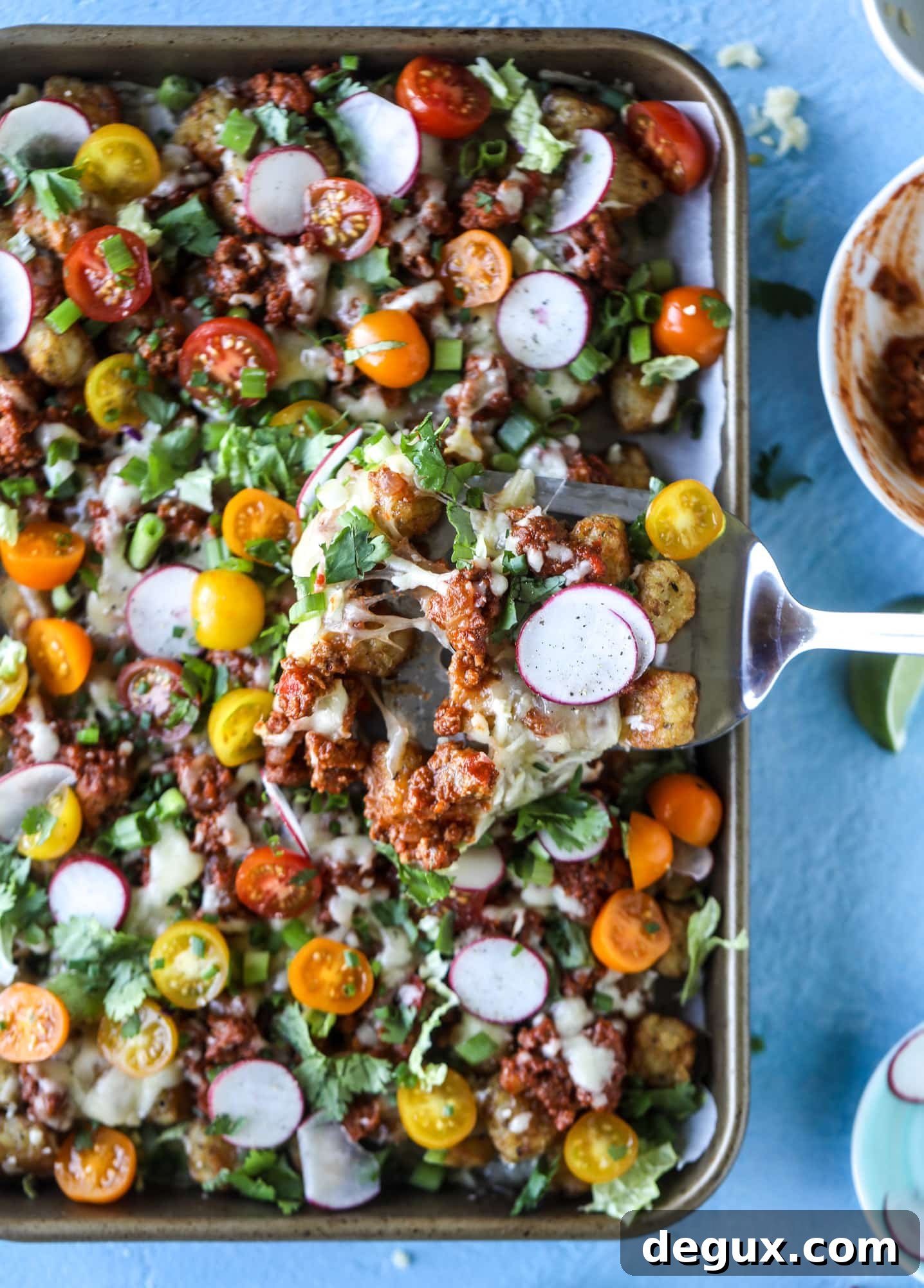Sloppy Joe Totchos Sheet Pan Recipe for Game Day Snacks 6 These tater tot nachos, otherwise known as totchos, are so delicious! They are cheesy and topped with a tangy, homemade sloppy joe mixture. Melted cheese, fresh tomatoes, scallions and chives come together for the best party food. I howsweeteats.com #totchos #tater #tot #nachos #sloppy #joes