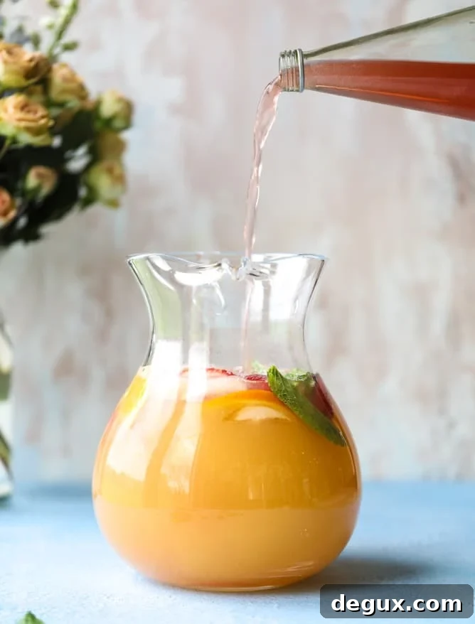 minted mimosa punch I howsweeteats.com #mimosa #punch #orangejuice #cocktails #champagne