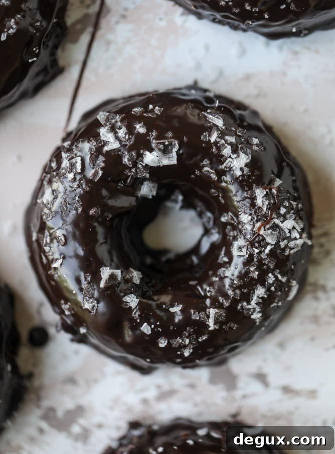 salted dark chocolate fudge donuts I howsweeteats.com #chocolate #donuts #doughtnuts #salted #fudge