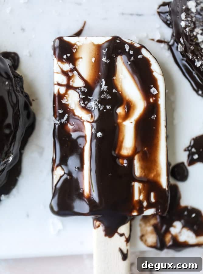 salted dark chocolate fudge donuts I howsweeteats.com #chocolate #donuts #doughtnuts #salted #fudge