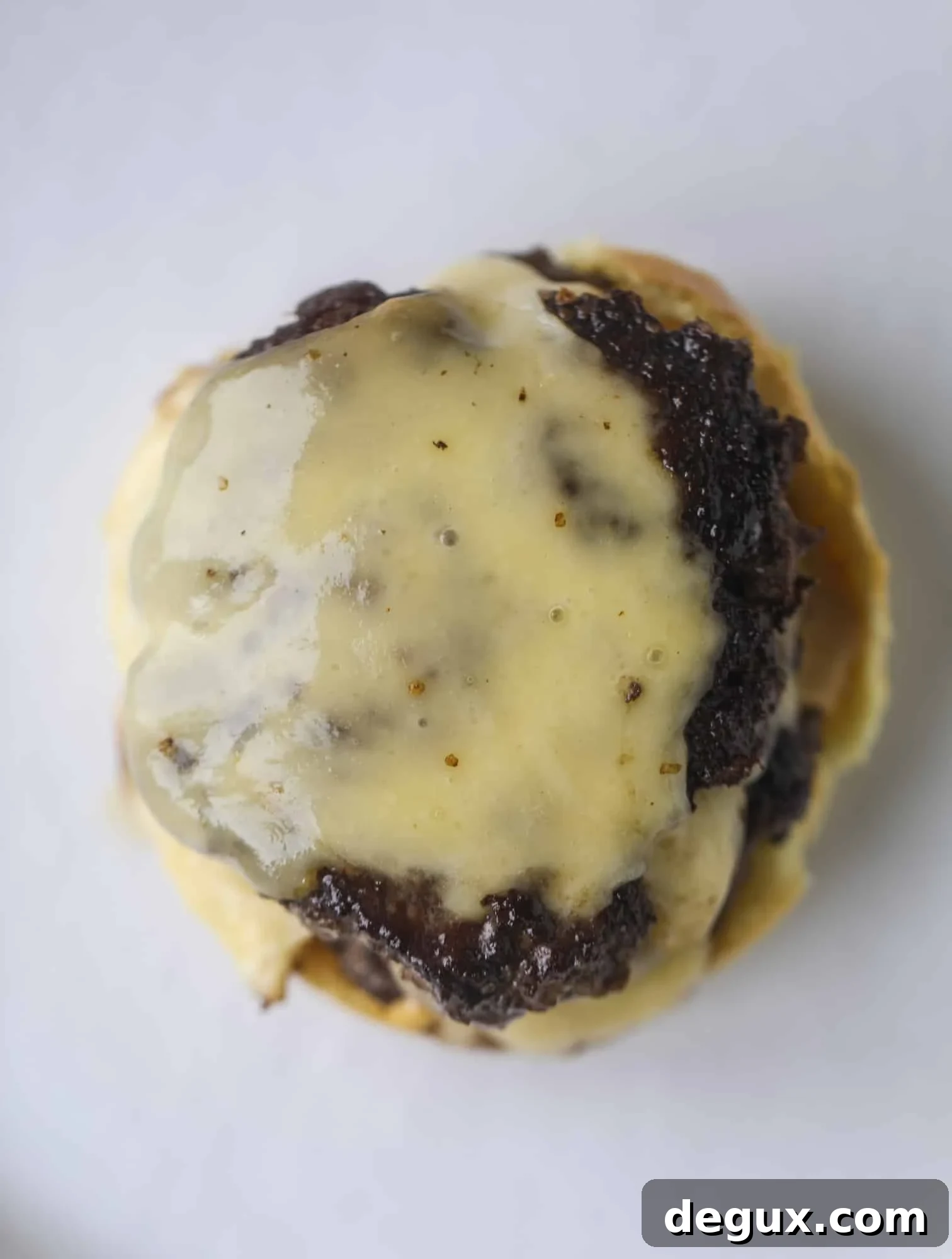 Pressing smash burgers in a skillet