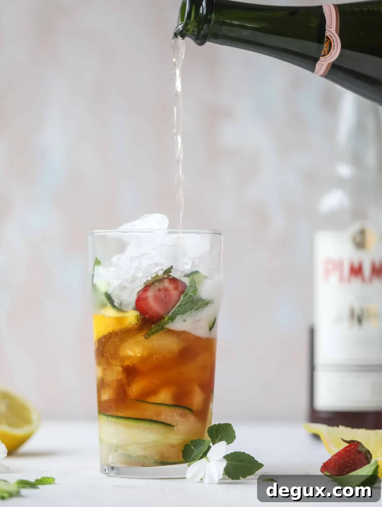 Sparkling Rosé Pimm’s Cups Recipe for Summer Cocktails 4 I love a delicious Pimm's Cup in the heart of summer! This was is topped with sparkling rosé wine and filled with strawberries, cucumbers and lemon wedges. It's super refreshing and perfect on hot hot days! I howsweeteats.com #pimms #cup #recipe #cocktails #rosé #sparkling #summer