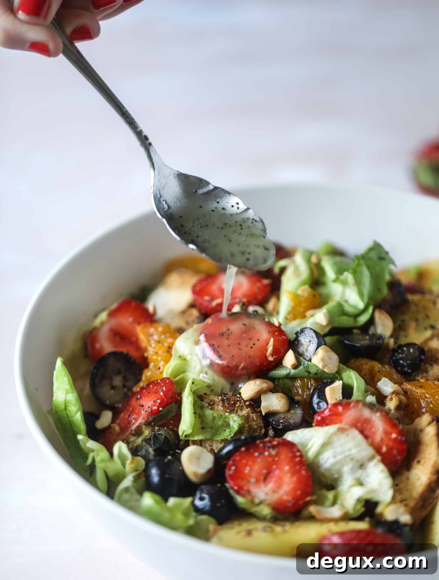 This copycat Panera strawberry poppyseed salad is absolutely delicious and refreshing and perfect for summer! Serve it with grilled chicken like the recipe here or swap for shrimp or fish. I howsweeteats.com #strawberry #poppyseed #salad #chicken #panera #copycat