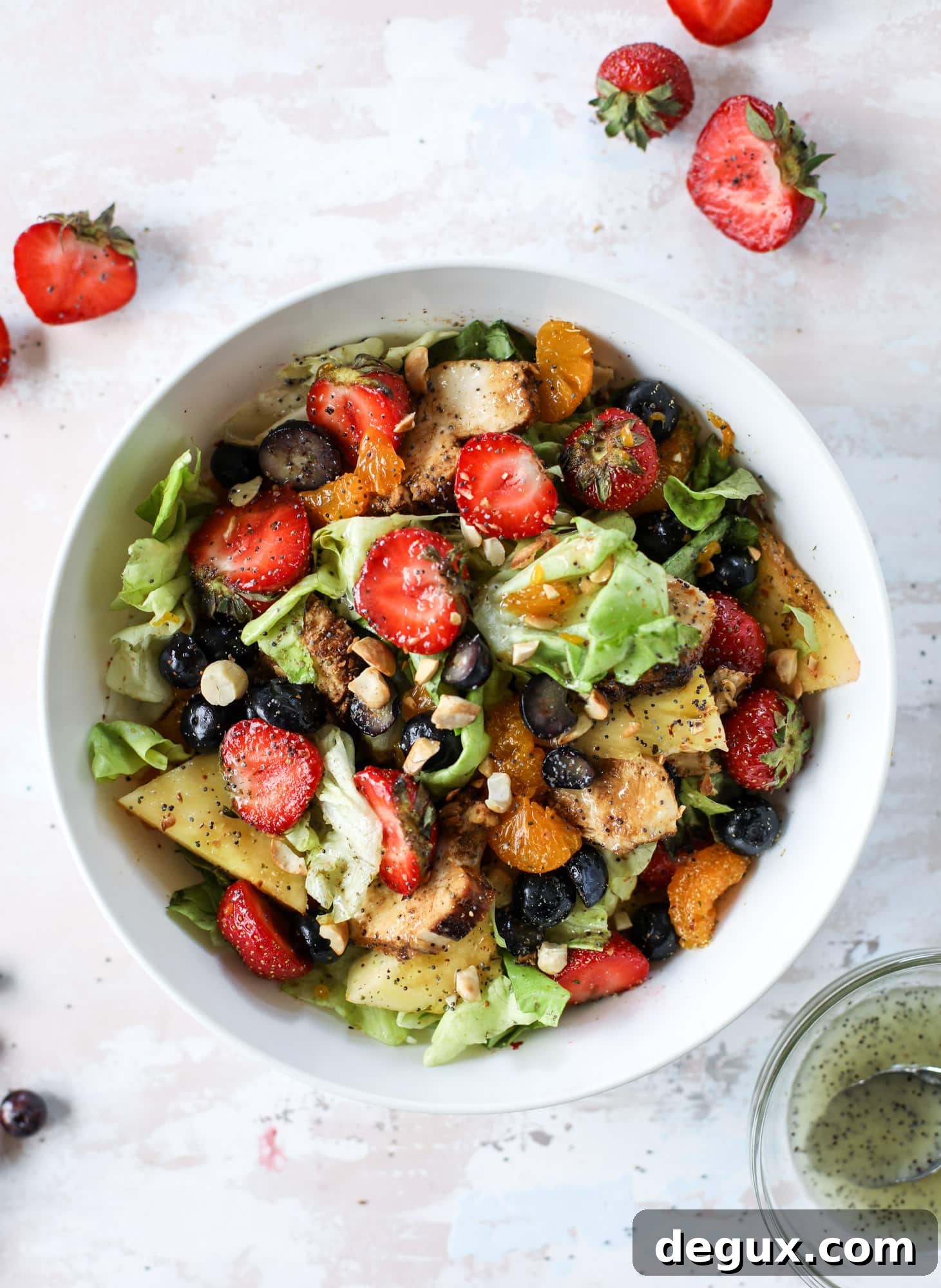 This copycat Panera strawberry poppyseed salad is absolutely delicious and refreshing and perfect for summer! Serve it with grilled chicken like the recipe here or swap for shrimp or fish. I howsweeteats.com #strawberry #poppyseed #salad #chicken #panera #copycat