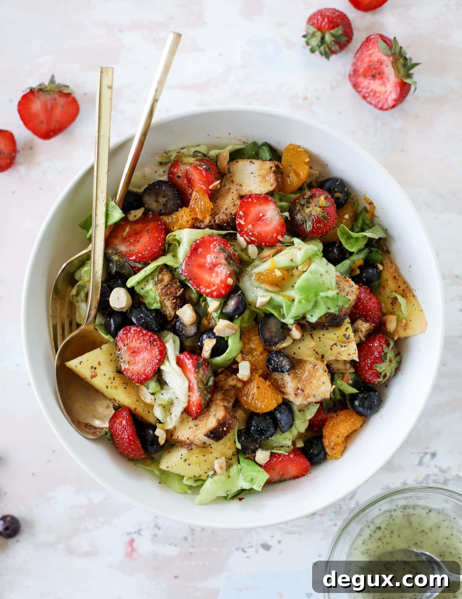 This copycat Panera strawberry poppyseed salad is absolutely delicious and refreshing and perfect for summer! Serve it with grilled chicken like the recipe here or swap for shrimp or fish. I howsweeteats.com #strawberry #poppyseed #salad #chicken #panera #copycat
