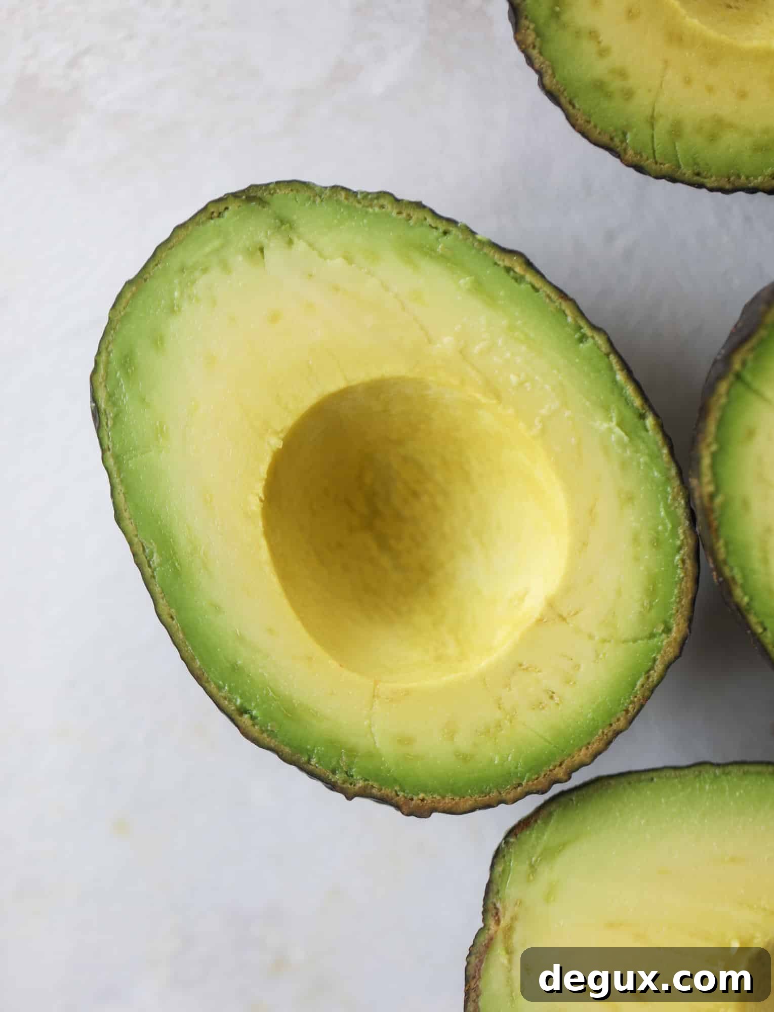 These smoky chicken salad stuffed avocados are lunchtime gold! They are super easy to throw together, satisfying and pretty darn great for you. Made with greek yogurt, some tangy mustard and dried cherries for sweetness, they are delish! I howsweeteats.com #chicken #salad #stuffed #avocados #greekyogurt