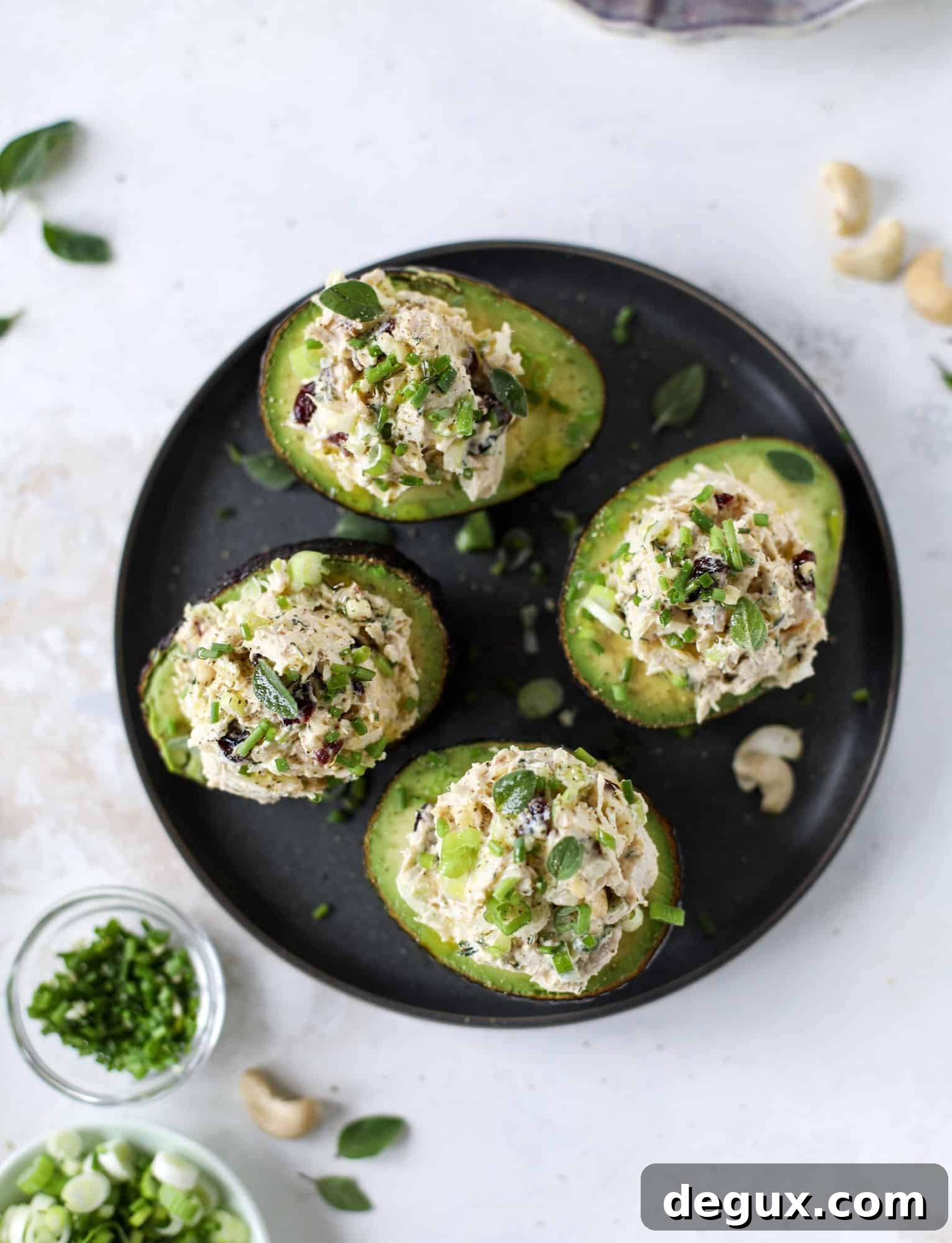 These smoky chicken salad stuffed avocados are lunchtime gold! They are super easy to throw together, satisfying and pretty darn great for you. Made with greek yogurt, some tangy mustard and dried cherries for sweetness, they are delish! I howsweeteats.com #chicken #salad #stuffed #avocados #greekyogurt