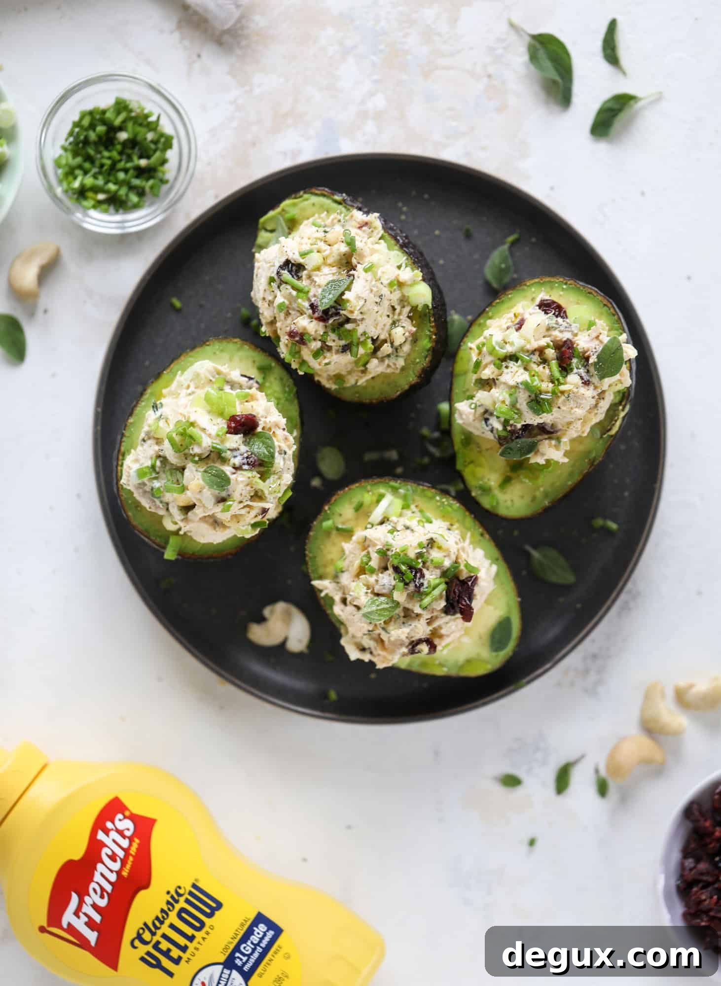 These smoky chicken salad stuffed avocados are lunchtime gold! They are super easy to throw together, satisfying and pretty darn great for you. Made with greek yogurt, some tangy mustard and dried cherries for sweetness, they are delish! I howsweeteats.com #chicken #salad #stuffed #avocados #greekyogurt