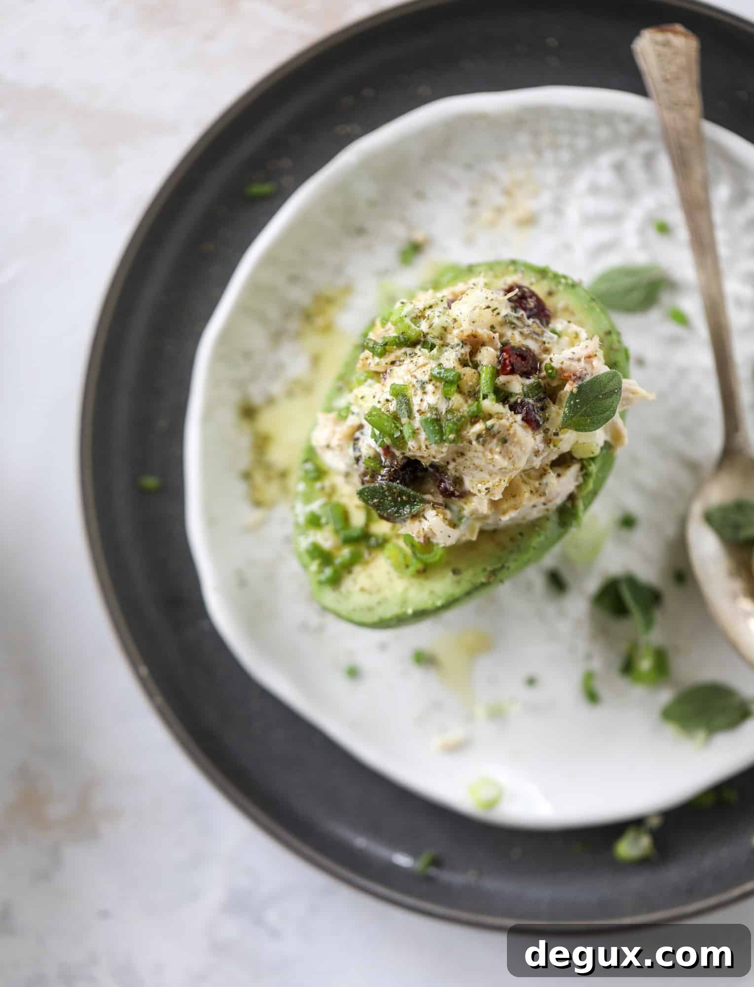 These smoky chicken salad stuffed avocados are lunchtime gold! They are super easy to throw together, satisfying and pretty darn great for you. Made with greek yogurt, some tangy mustard and dried cherries for sweetness, they are delish! I howsweeteats.com #chicken #salad #stuffed #avocados #greekyogurt