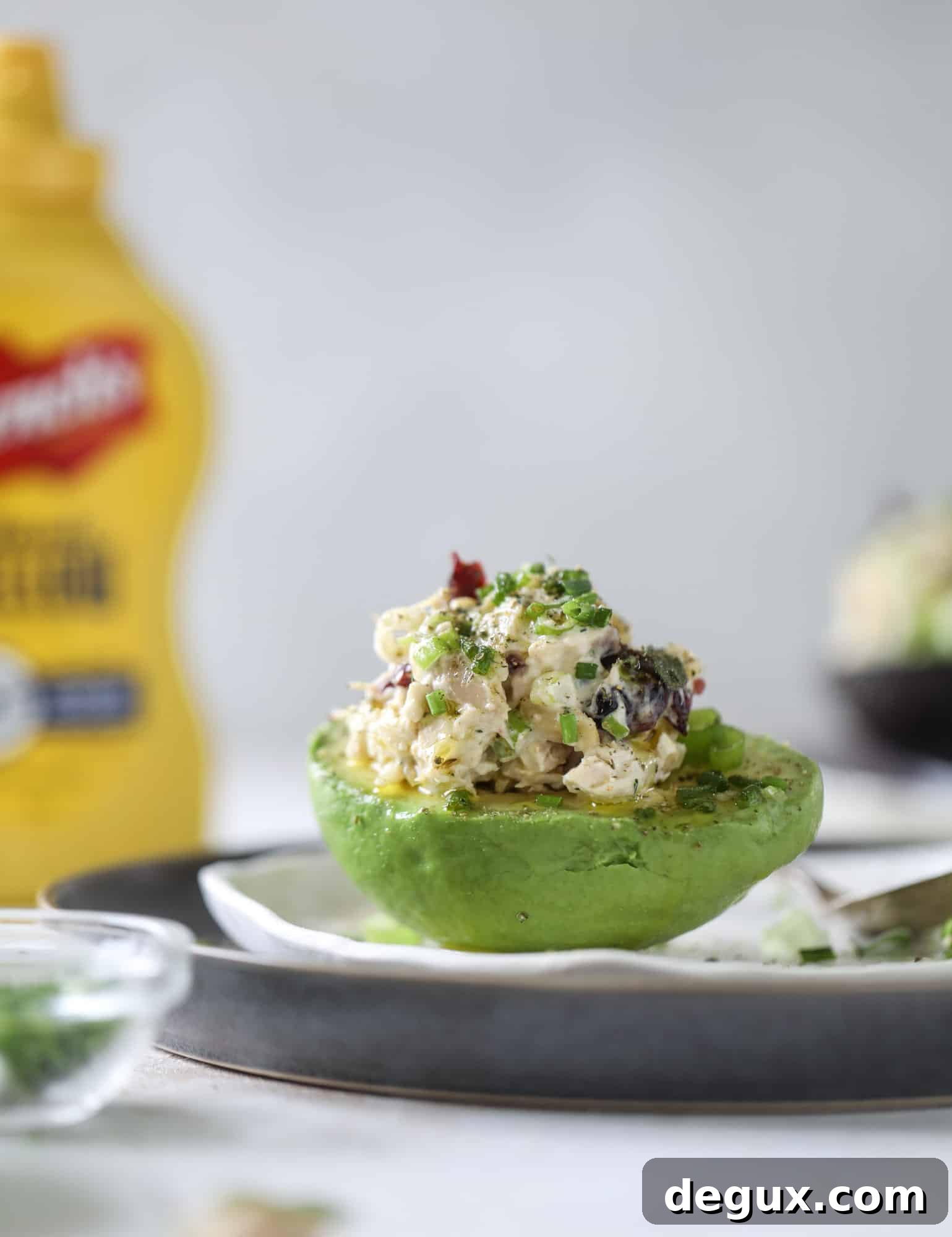 These smoky chicken salad stuffed avocados are lunchtime gold! They are super easy to throw together, satisfying and pretty darn great for you. Made with greek yogurt, some tangy mustard and dried cherries for sweetness, they are delish! I howsweeteats.com #chicken #salad #stuffed #avocados #greekyogurt