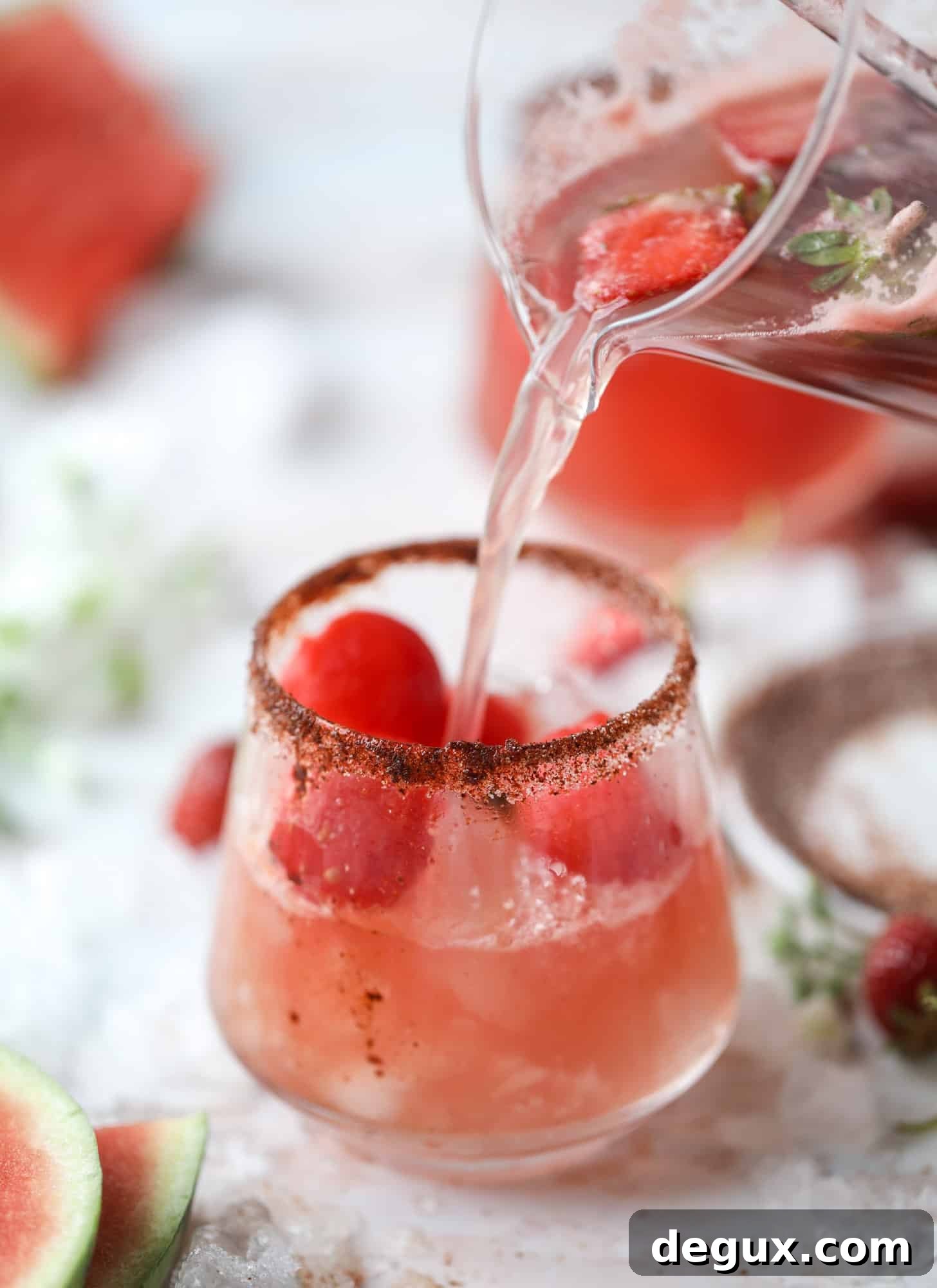 This spicy watermelon sangria is super refreshing, light, delicious and perfect for a hot summer day! Complete with an entire bottle of rosé, watermelon juice, melon balls, strawberries and brandy, this is the best summer cocktail in a pitcher! I howsweeteats.com #spicy #watermelon #sangria #cocktails #rosé
