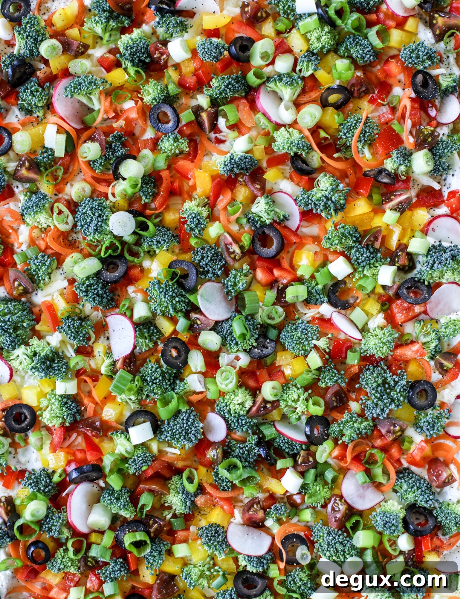 My mom's classic appetizer, the old school veggie pizza, is perfect for summer parties both indoor and out! A flaky pastry crust, a flavorful mascarpone greek yogurt base and tons of fresh chopped vegetables on top. It's a winning combination!