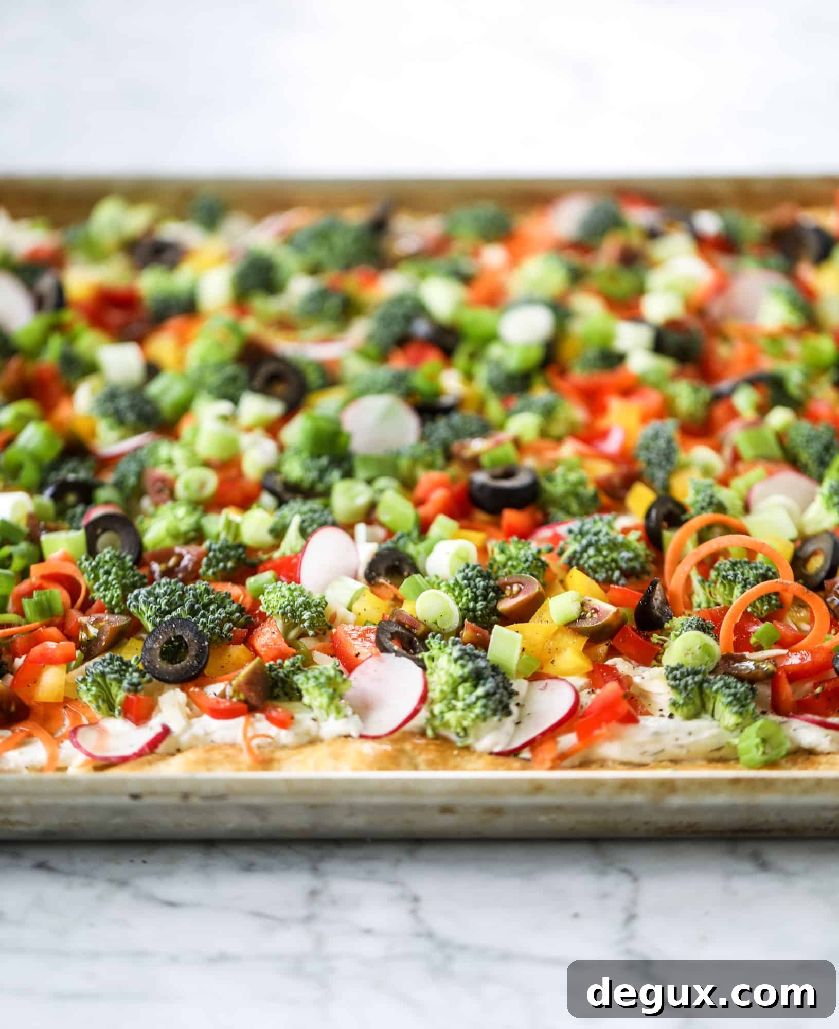 My mom's classic appetizer, the old school veggie pizza, is perfect for summer parties both indoor and out! A flaky pastry crust, a flavorful mascarpone greek yogurt base and tons of fresh chopped vegetables on top. It's a winning combination!
