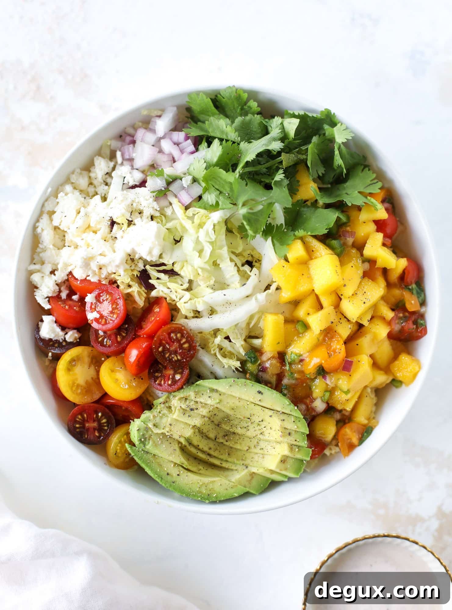 These fish taco bowls are an amazing weeknight meal idea! Napa cabbage for the base, a homemade chipotle crema, avocado, mango pico de gallo, spicy broiled white fish and lots of lime. Major flavor explosion and so easy too! I howsweeteats.com #fish #taco #bowls #spicy #healthy #dinner