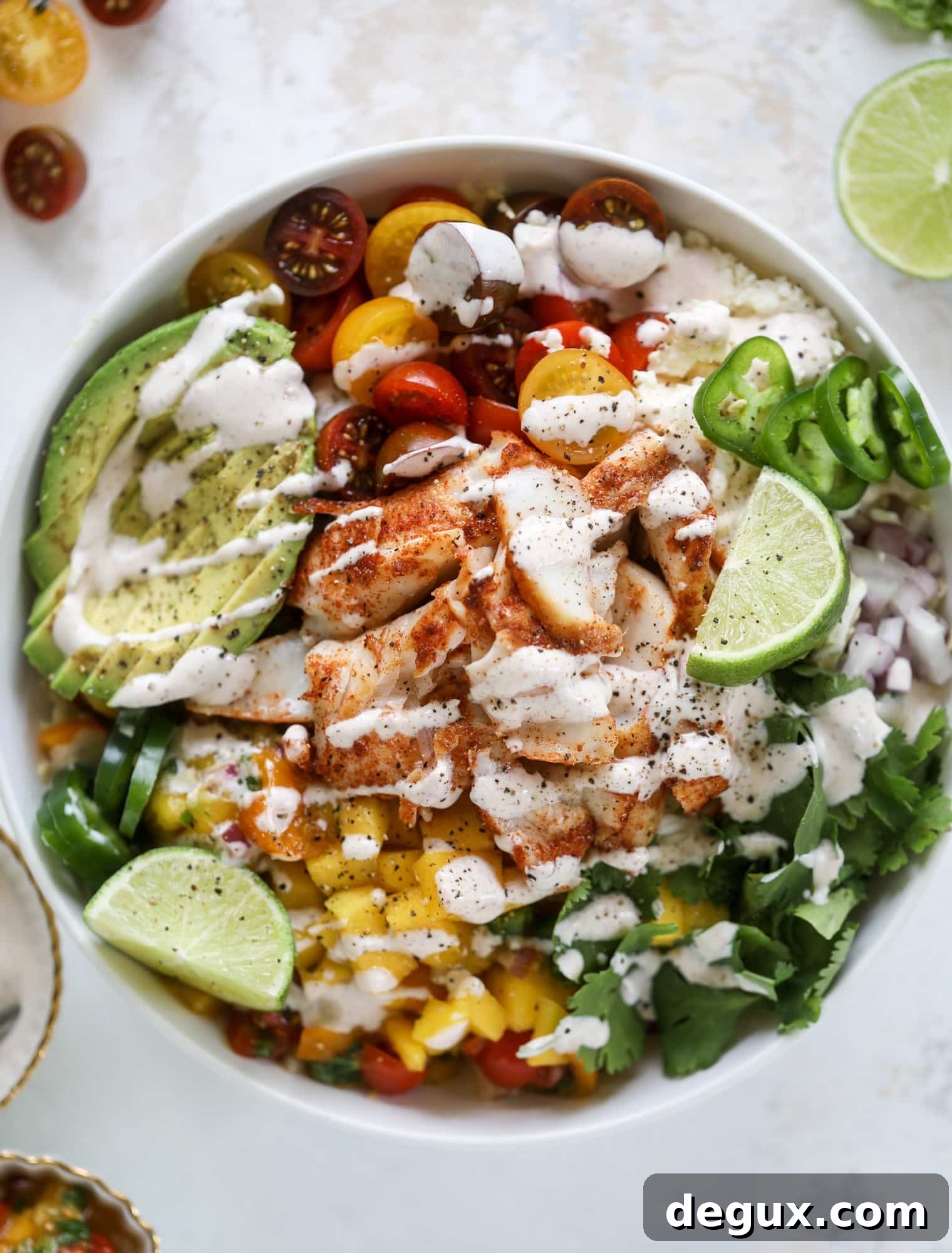These fish taco bowls are an amazing weeknight meal idea! Napa cabbage for the base, a homemade chipotle crema, avocado, mango pico de gallo, spicy broiled white fish and lots of lime. Major flavor explosion and so easy too! I howsweeteats.com #fish #taco #bowls #spicy #healthy #dinner