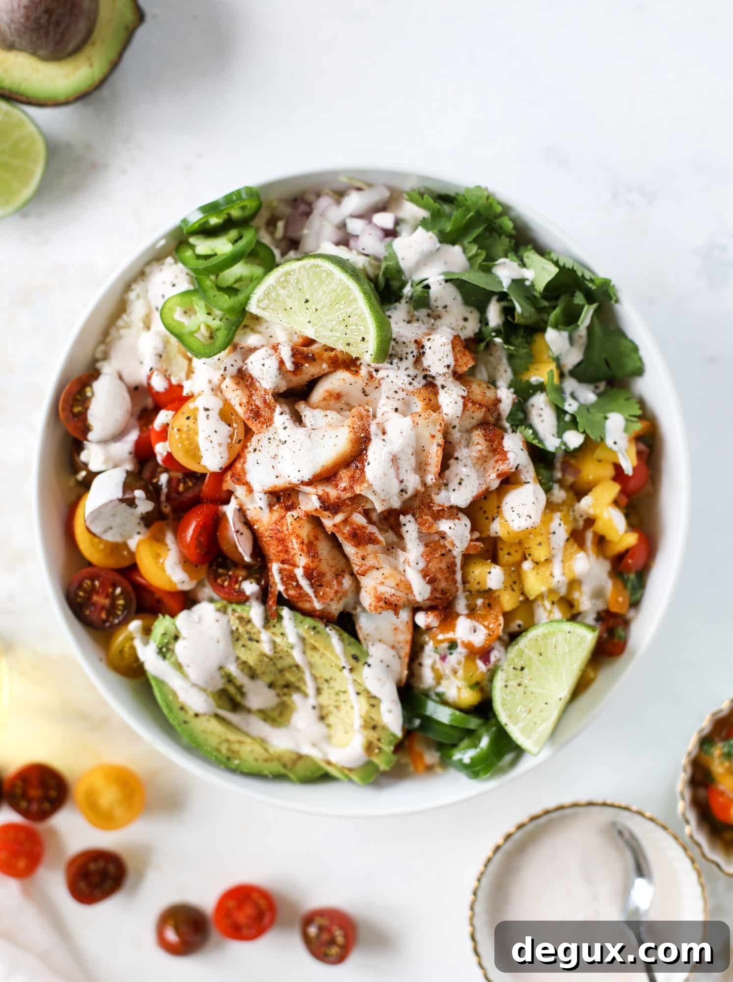 These fish taco bowls are an amazing weeknight meal idea! Napa cabbage for the base, a homemade chipotle crema, avocado, mango pico de gallo, spicy broiled white fish and lots of lime. Major flavor explosion and so easy too! I howsweeteats.com #fish #taco #bowls #spicy #healthy #dinner