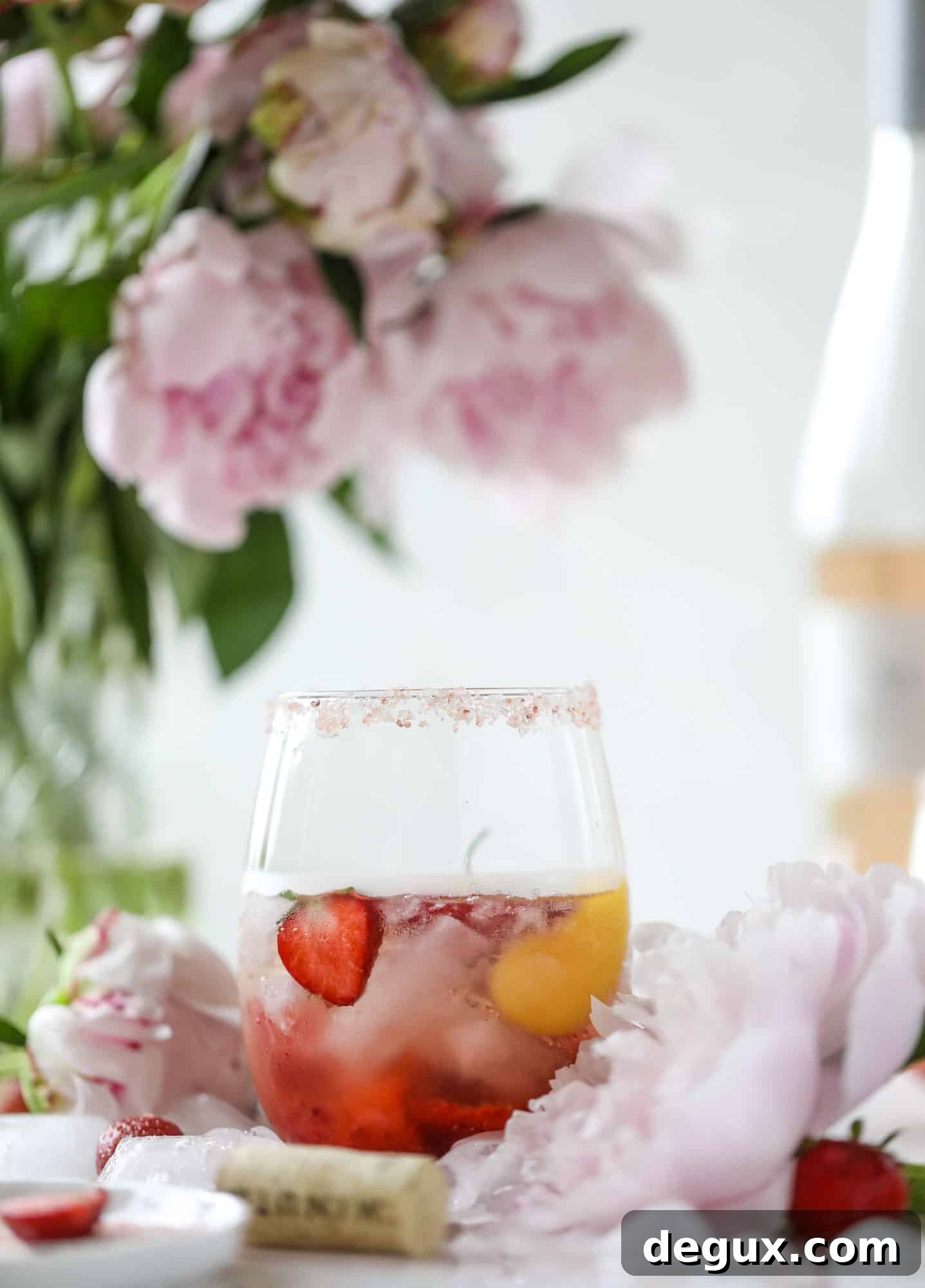 Tequila rosé spritz cocktail: muddled strawberries and honey, a shot of tequila, finished with rosé wine.