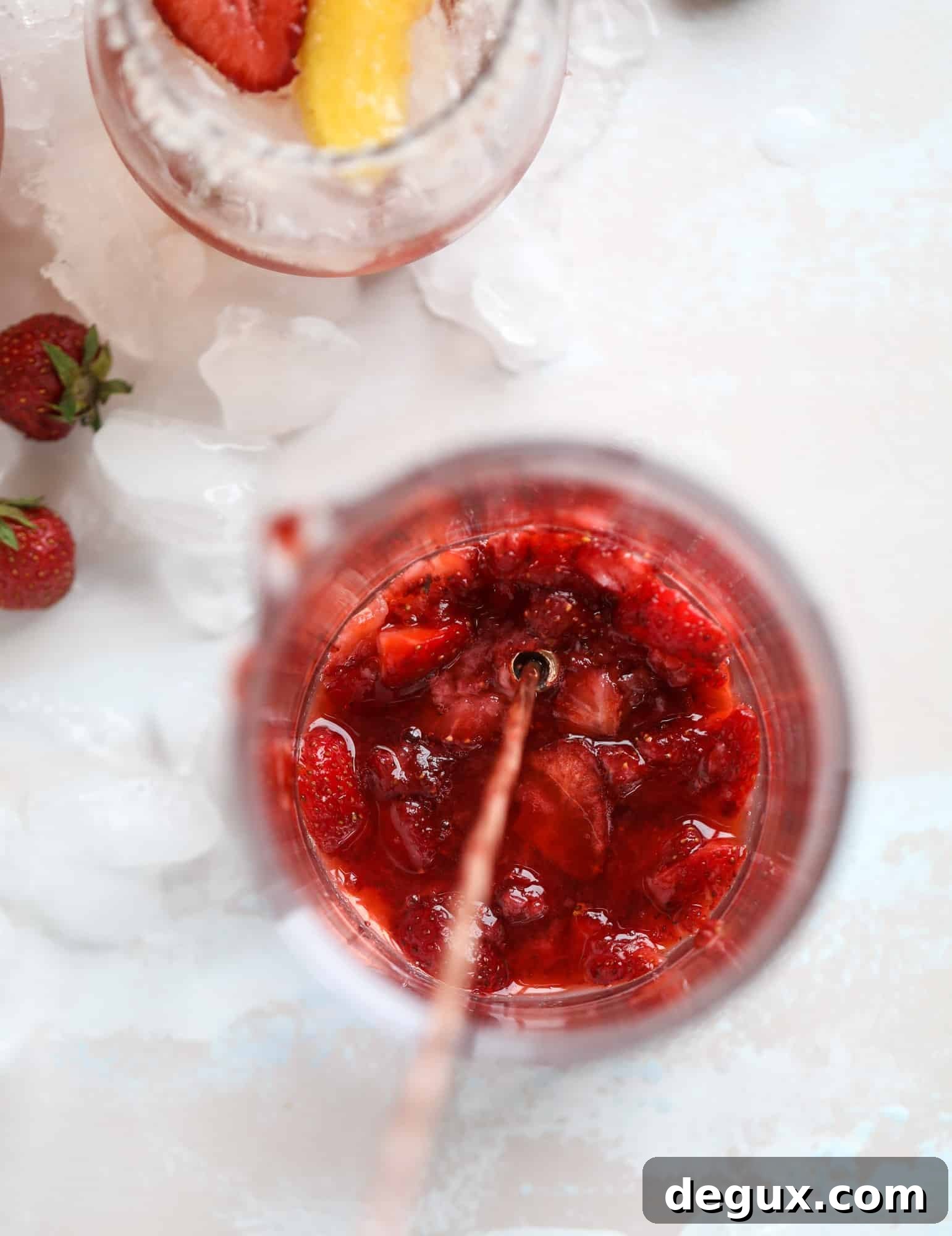 Tequila rosé spritz cocktail: muddled strawberries and honey, a shot of tequila, finished with rosé wine.