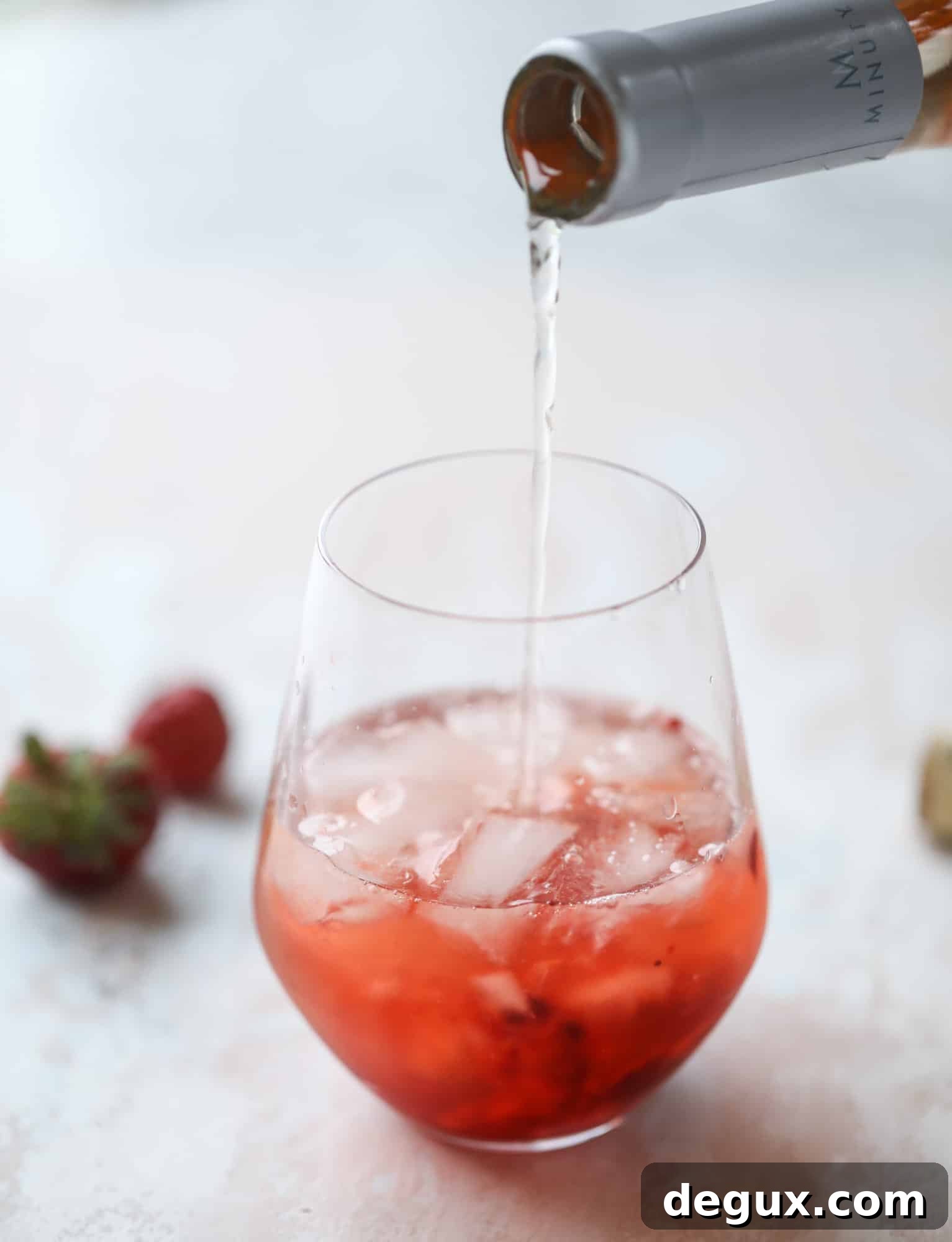 Tequila rosé spritz cocktail: muddled strawberries and honey, a shot of tequila, finished with rosé wine.