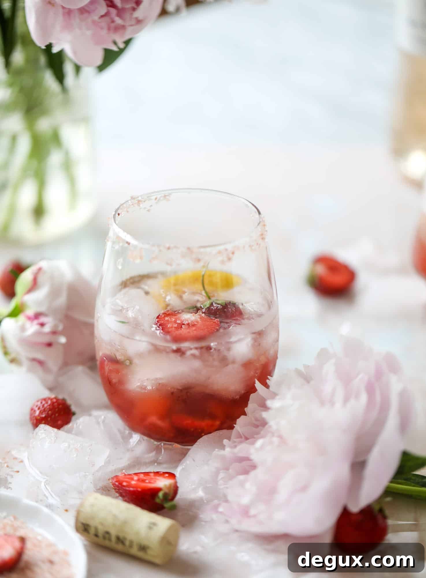Tequila rosé spritz cocktail: muddled strawberries and honey, a shot of tequila, finished with rosé wine.
