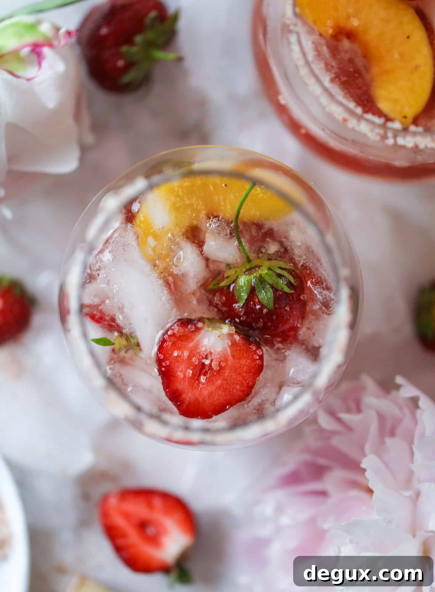Tequila rosé spritz cocktail: muddled strawberries and honey, a shot of tequila, finished with rosé wine.