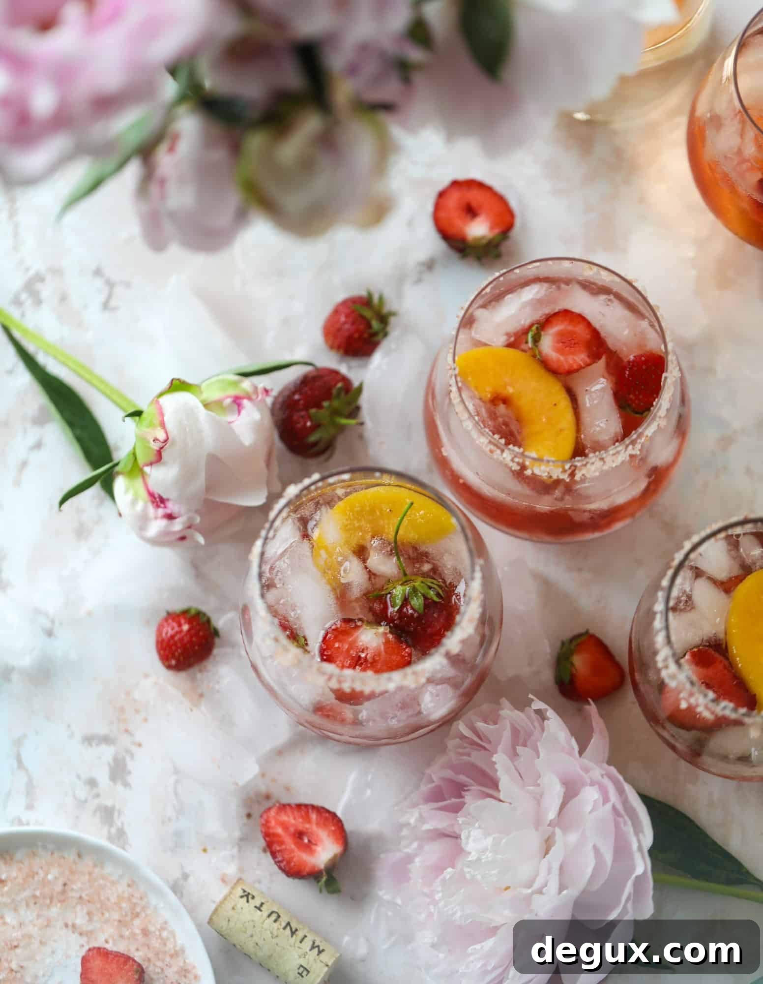 Tequila rosé spritz cocktail: muddled strawberries and honey, a shot of tequila, finished with rosé wine.