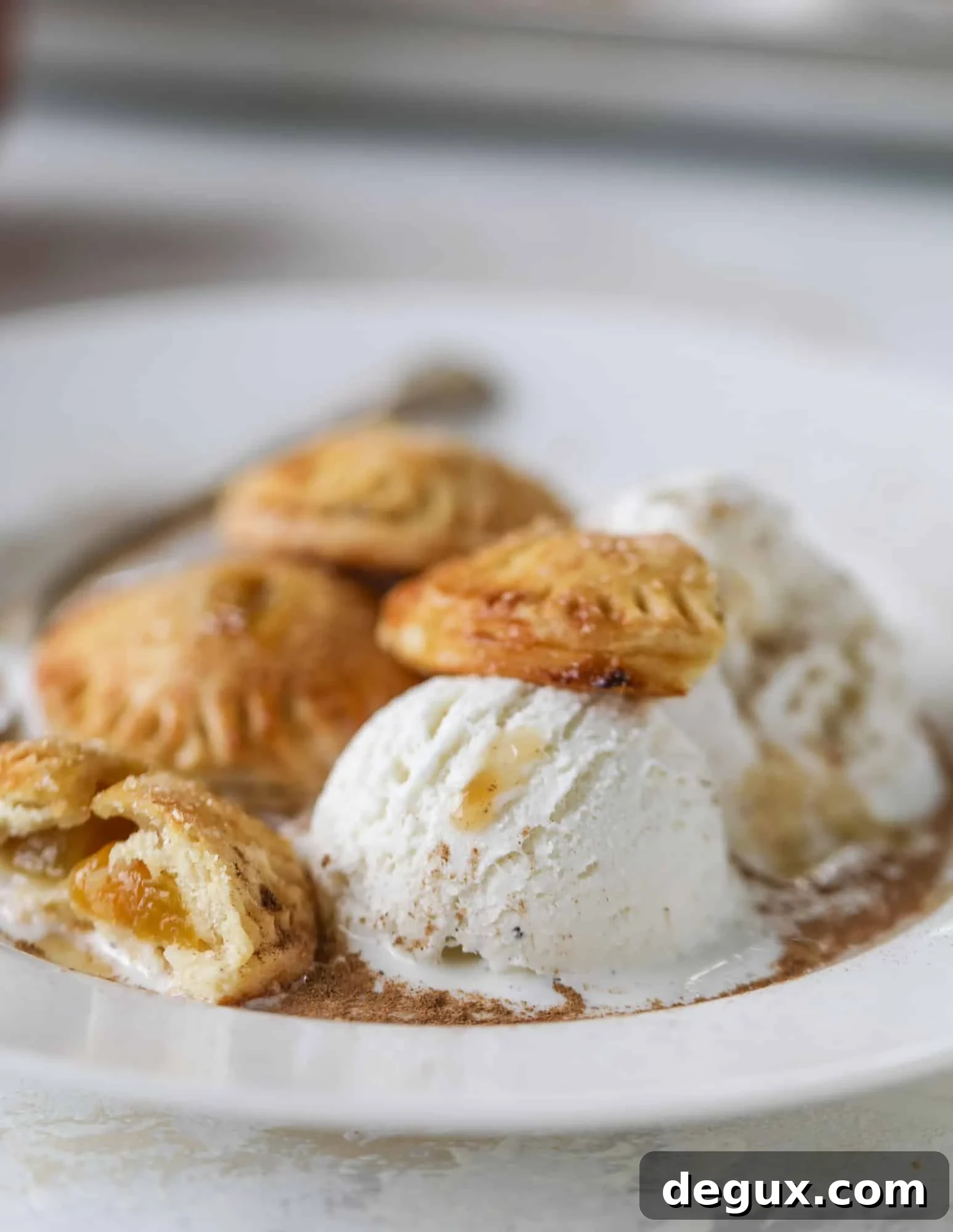 These little peach hand pies are super easy to make and oh-so delicious for summer! A warm and syrupy homemade peach filling made with brown sugar and bourbon, stuck inside a flakey all-butter crust and sprinkled with coarse sugar. SO GOOD. I howsweeteats.com #peach #hand #pies #mini #dessert #summer