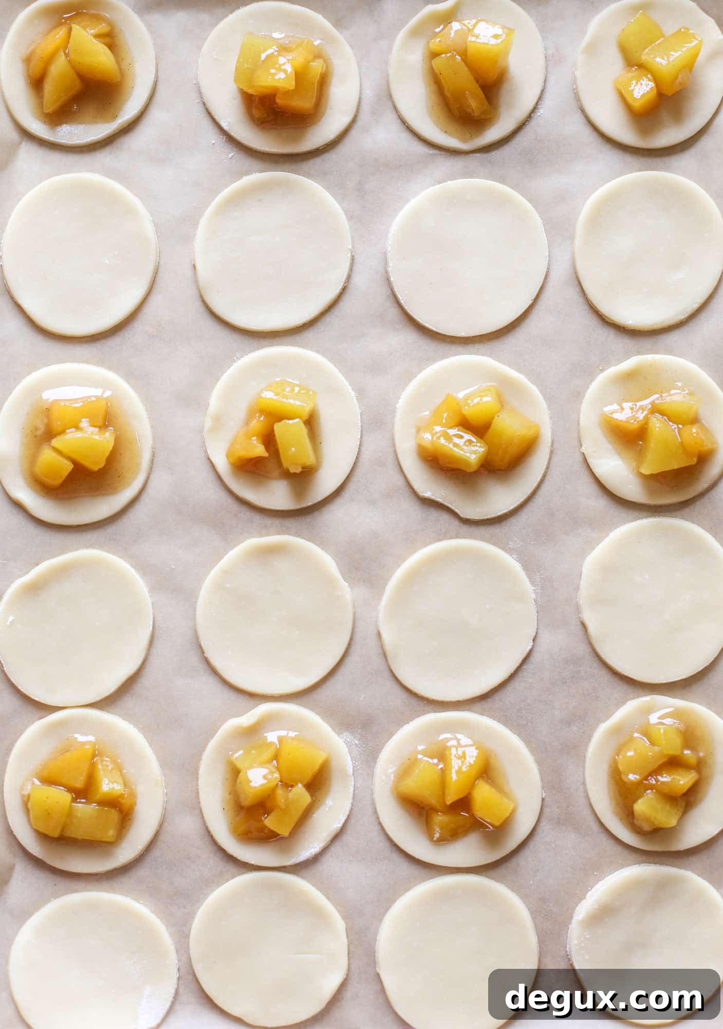 These little peach hand pies are super easy to make and oh-so delicious for summer! A warm and syrupy homemade peach filling made with brown sugar and bourbon, stuck inside a flakey all-butter crust and sprinkled with coarse sugar. SO GOOD. I howsweeteats.com #peach #hand #pies #mini #dessert #summer