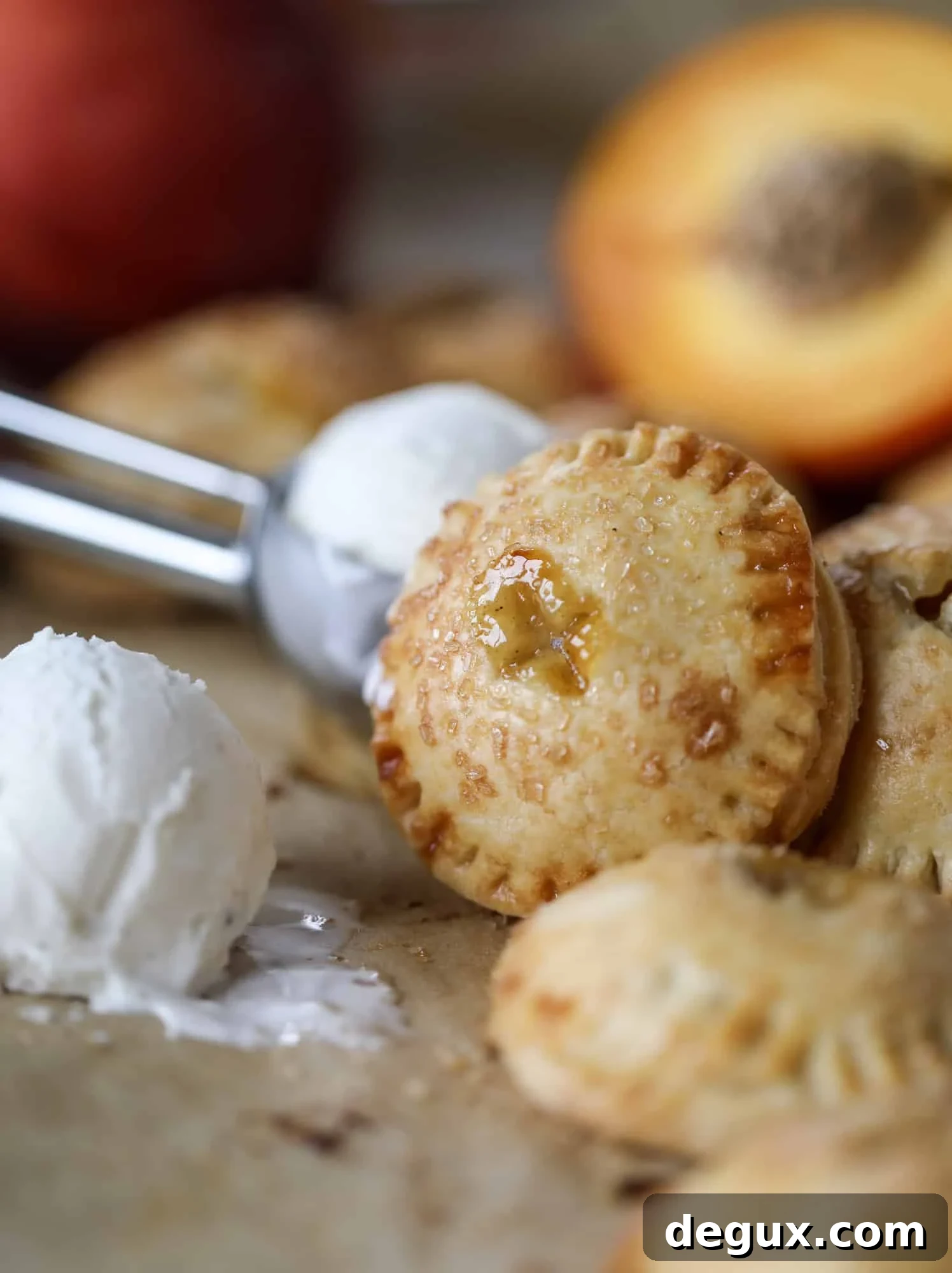 These little peach hand pies are super easy to make and oh-so delicious for summer! A warm and syrupy homemade peach filling made with brown sugar and bourbon, stuck inside a flakey all-butter crust and sprinkled with coarse sugar. SO GOOD. I howsweeteats.com #peach #hand #pies #mini #dessert #summer