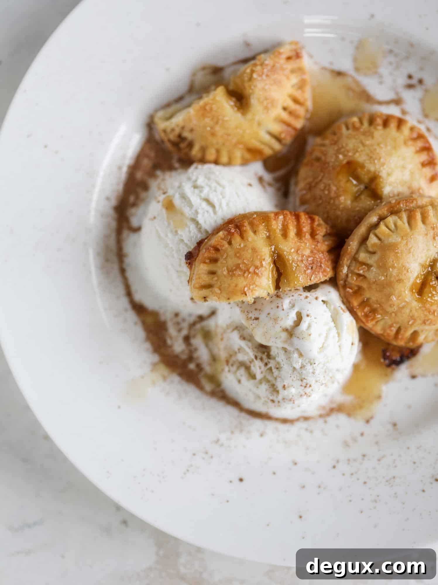 These little peach hand pies are super easy to make and oh-so delicious for summer! A warm and syrupy homemade peach filling made with brown sugar and bourbon, stuck inside a flakey all-butter crust and sprinkled with coarse sugar. SO GOOD. I howsweeteats.com #peach #hand #pies #mini #dessert #summer