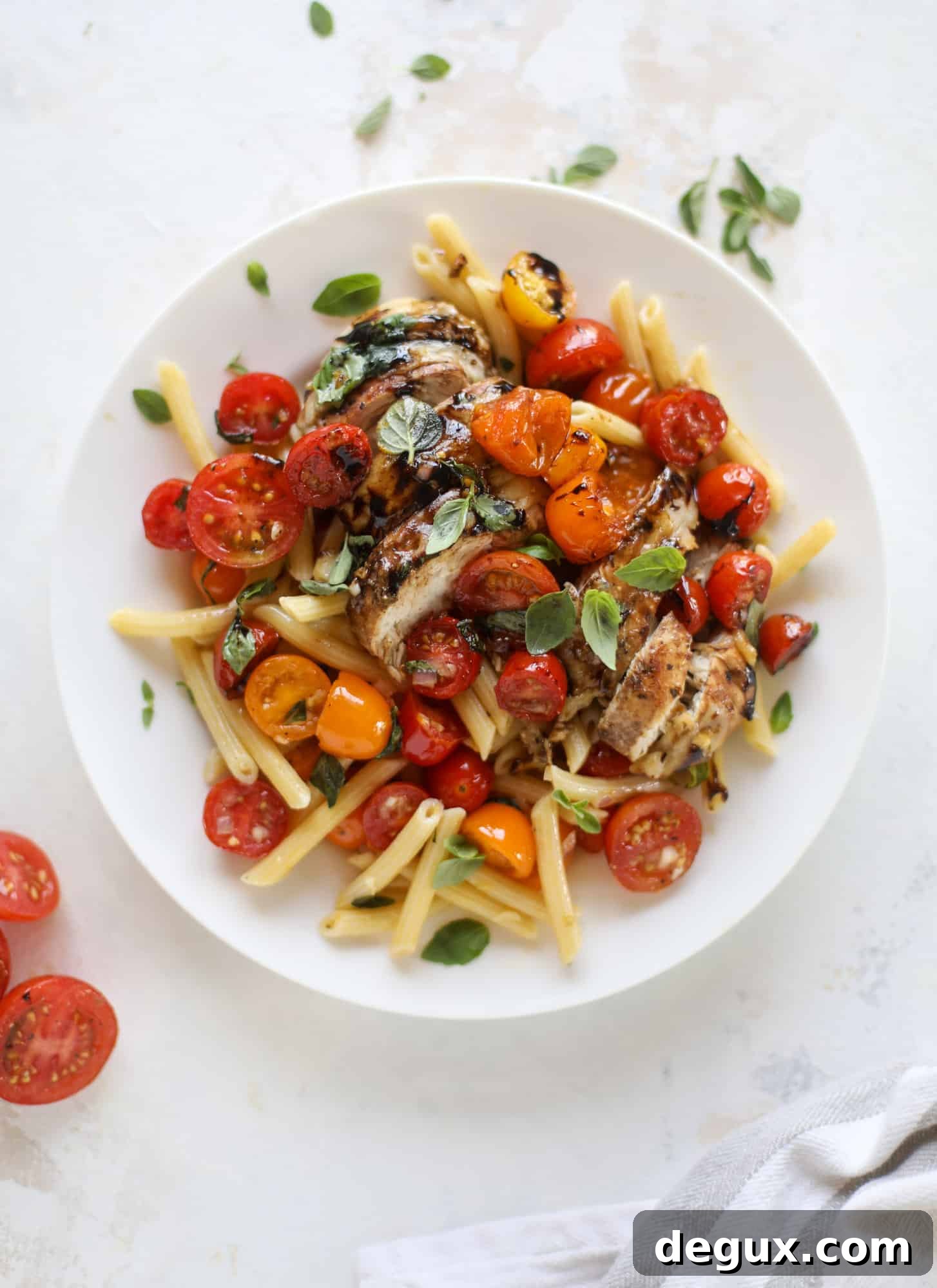 This bruschetta chicken is the perfect summer garden meal! Juicy, flavorful chicken topped with fresh tomatoes, garlic, basil and balsamic glaze, along with a touch of cheese. Served with pasta, it's an incredible meal. I howsweeteats.com #bruschetta #chicken #pasta #tomatoes #basil 