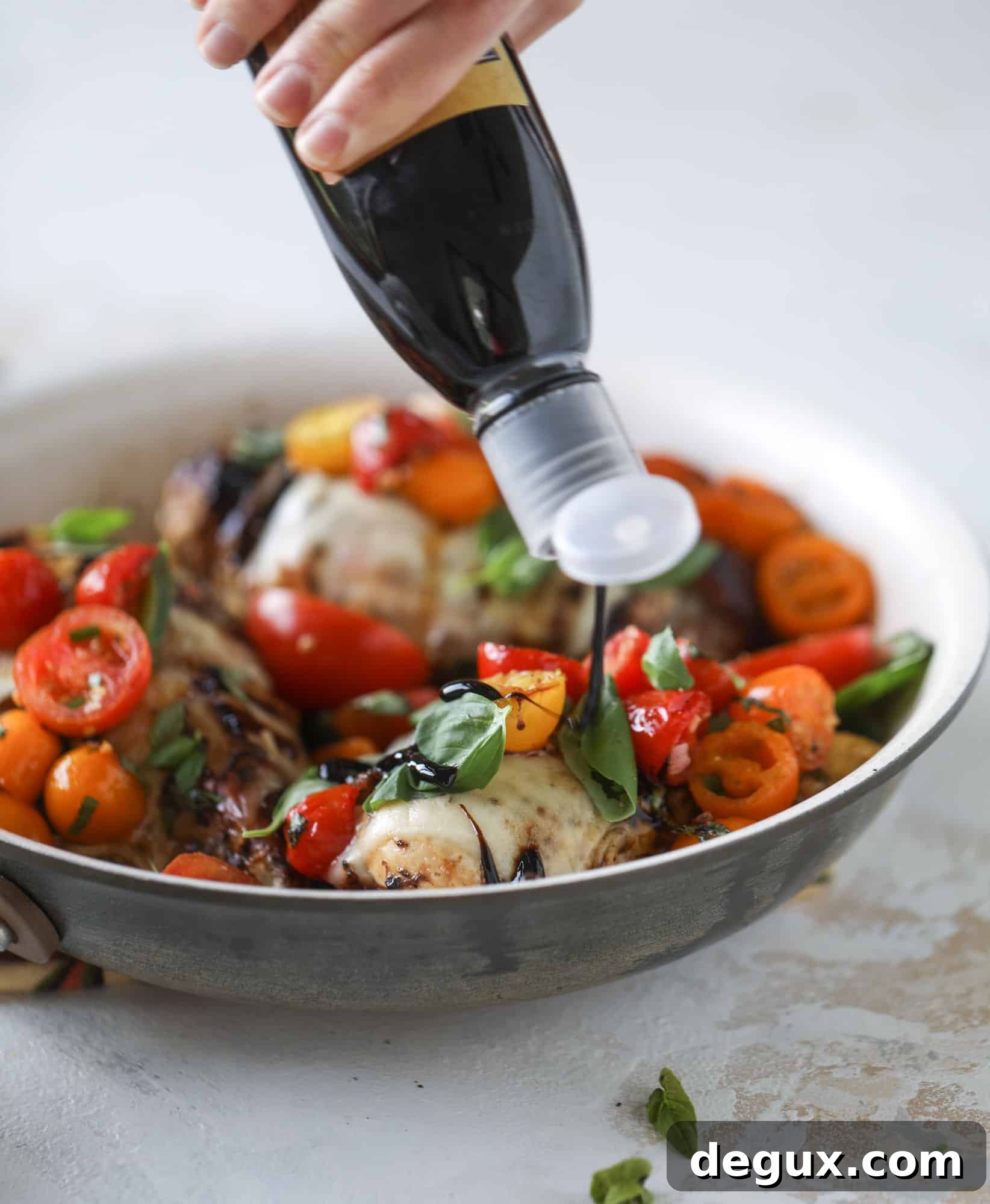 This bruschetta chicken is the perfect summer garden meal! Juicy, flavorful chicken topped with fresh tomatoes, garlic, basil and balsamic glaze, along with a touch of cheese. Served with pasta, it's an incredible meal. I howsweeteats.com #bruschetta #chicken #pasta #tomatoes #basil 