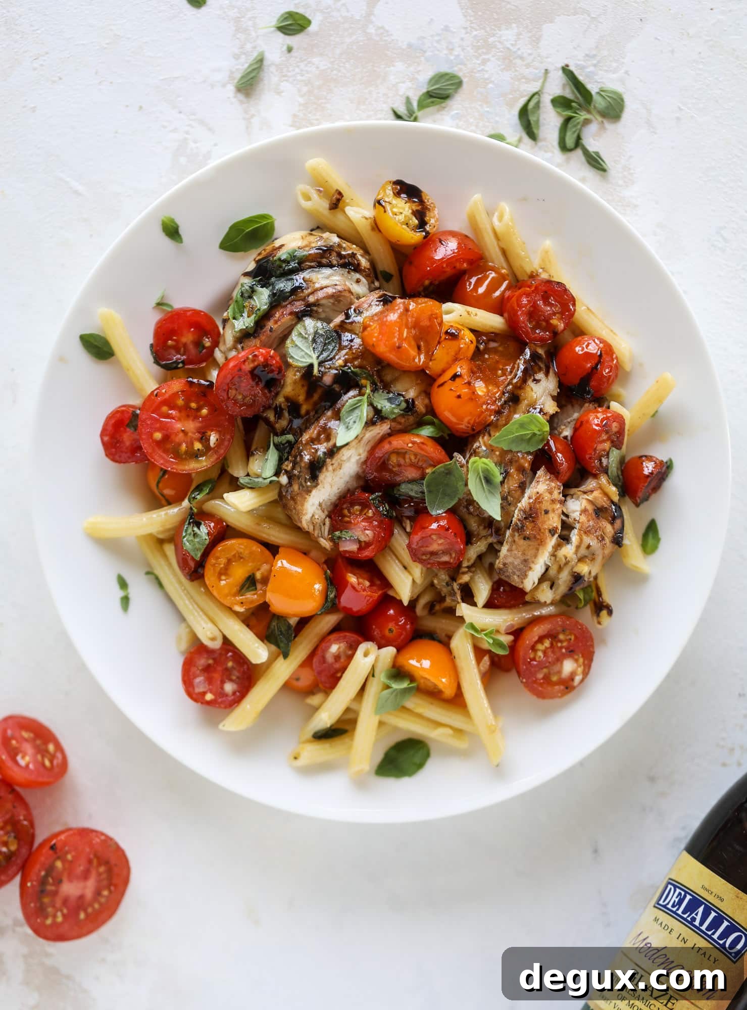 This bruschetta chicken is the perfect summer garden meal! Juicy, flavorful chicken topped with fresh tomatoes, garlic, basil and balsamic glaze, along with a touch of cheese. Served with pasta, it's an incredible meal. I howsweeteats.com #bruschetta #chicken #pasta #tomatoes #basil 
