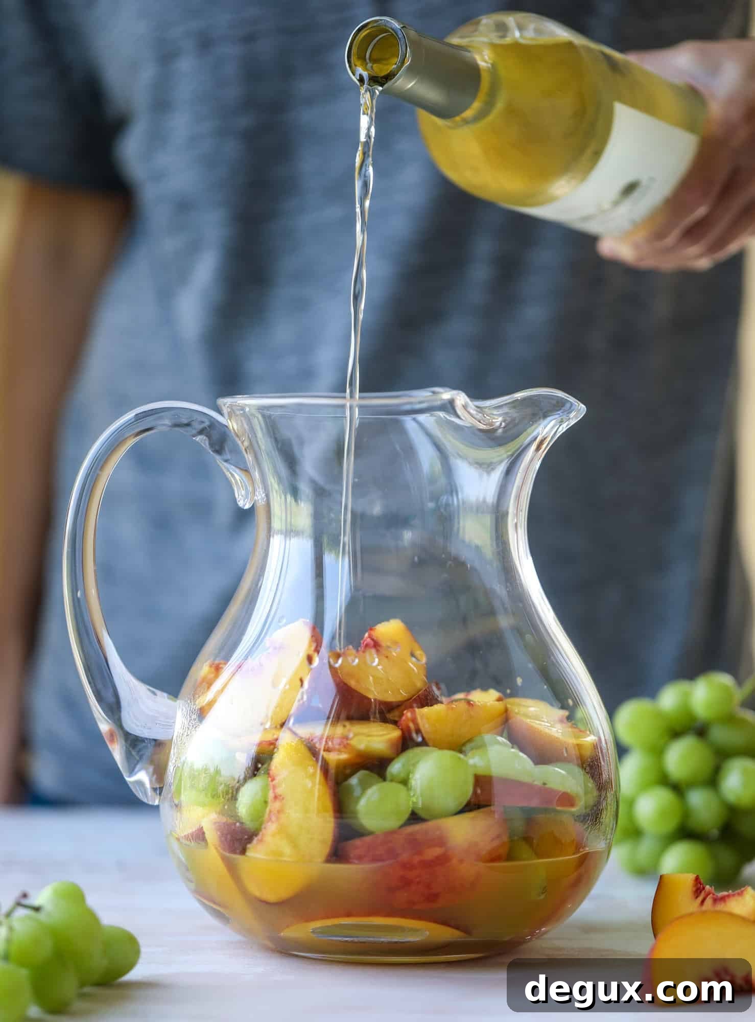 Pinot grigio sangria with peach nectar, fresh and frozen peach slices, brandy and bubbles.