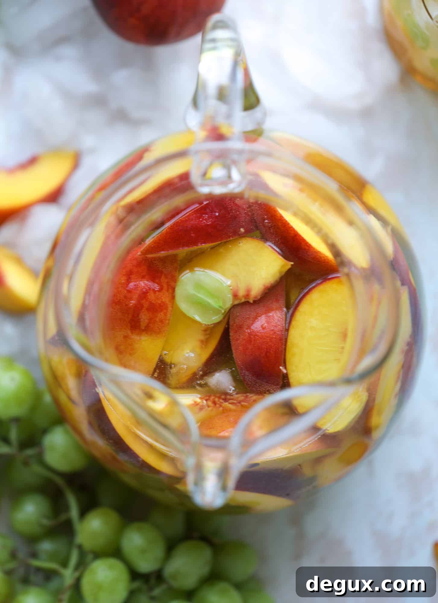 Pinot grigio sangria with peach nectar, fresh and frozen peach slices, brandy and bubbles.