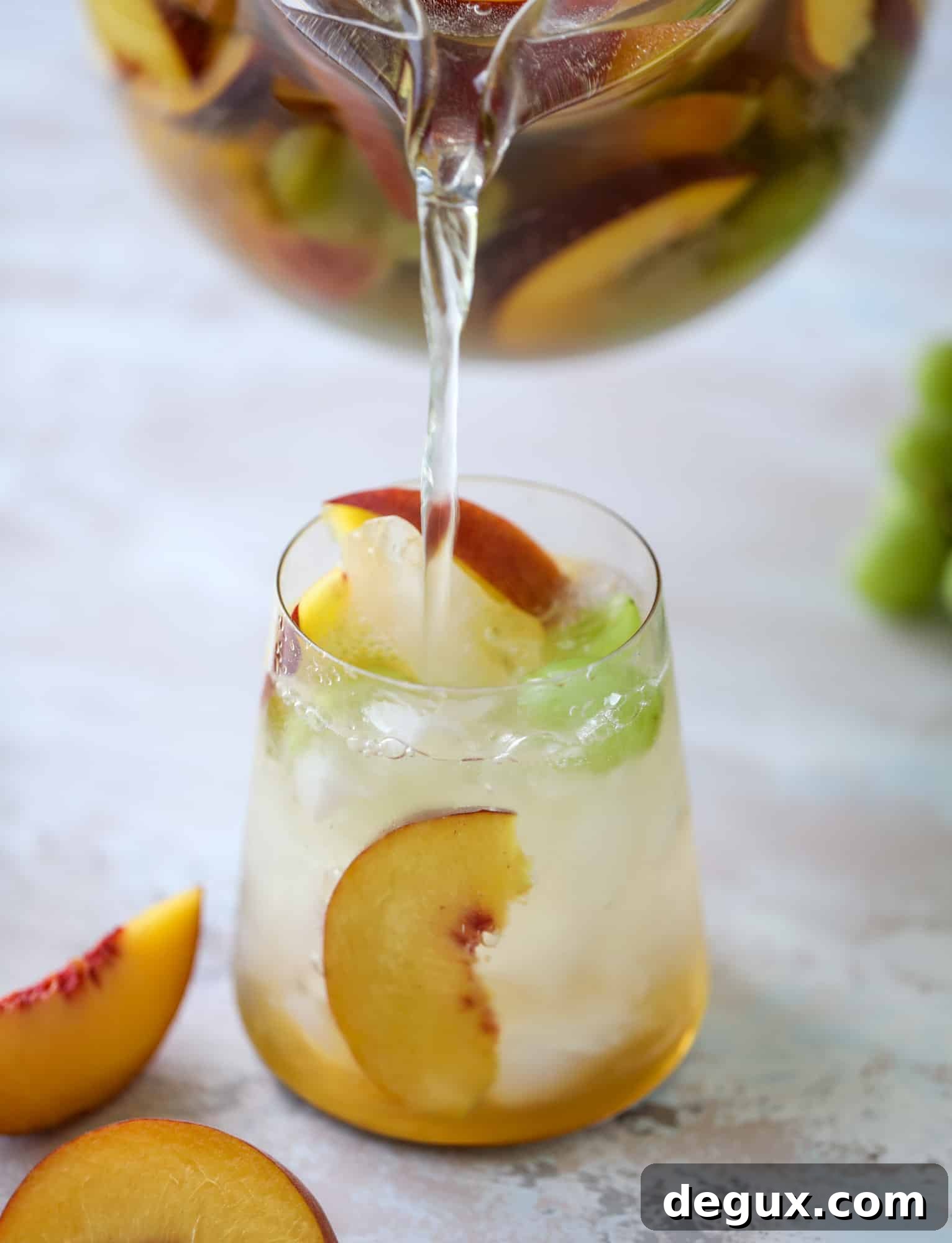 Pinot grigio sangria with peach nectar, fresh and frozen peach slices, brandy and bubbles.
