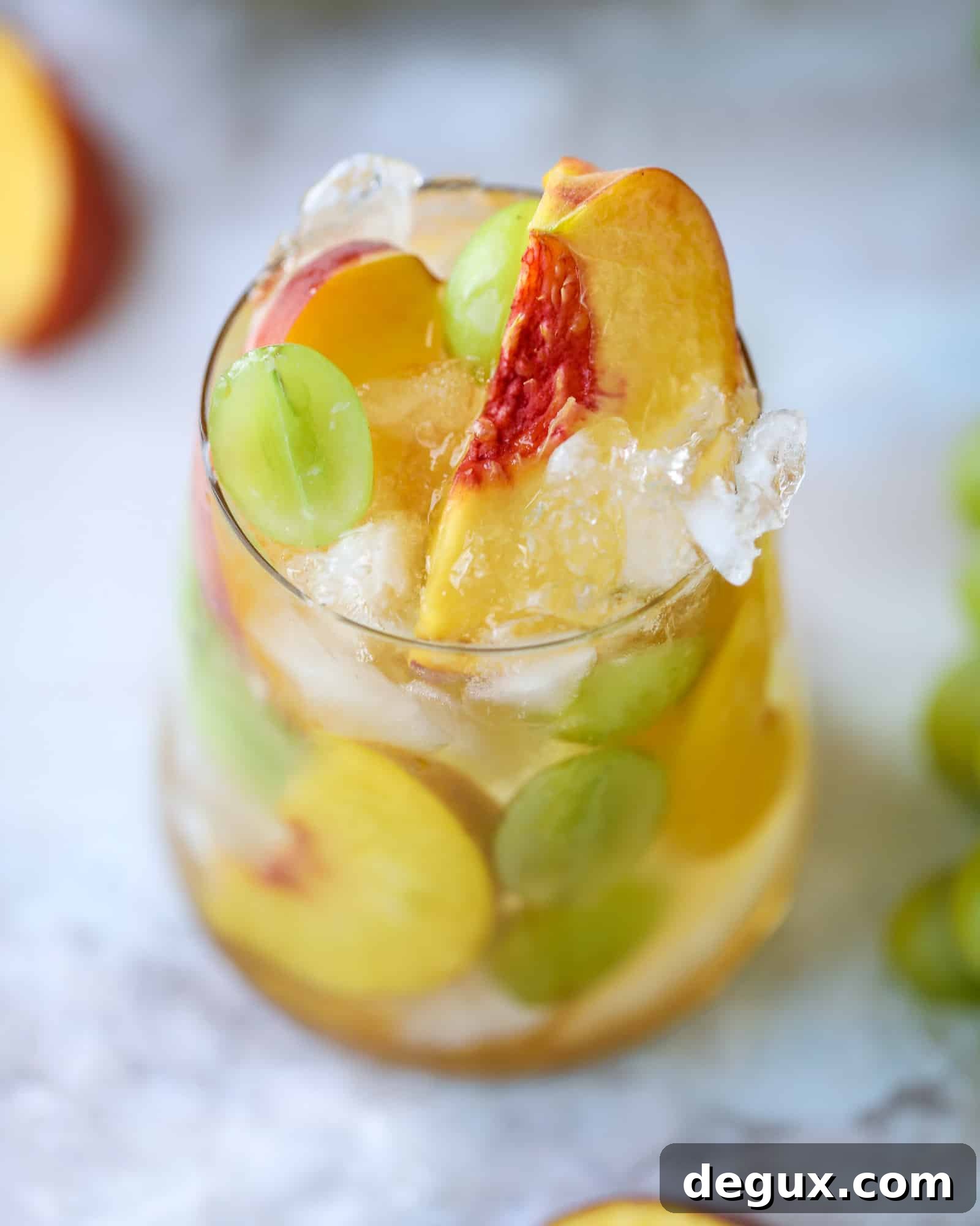 Pinot grigio sangria with peach nectar, fresh and frozen peach slices, brandy and bubbles.