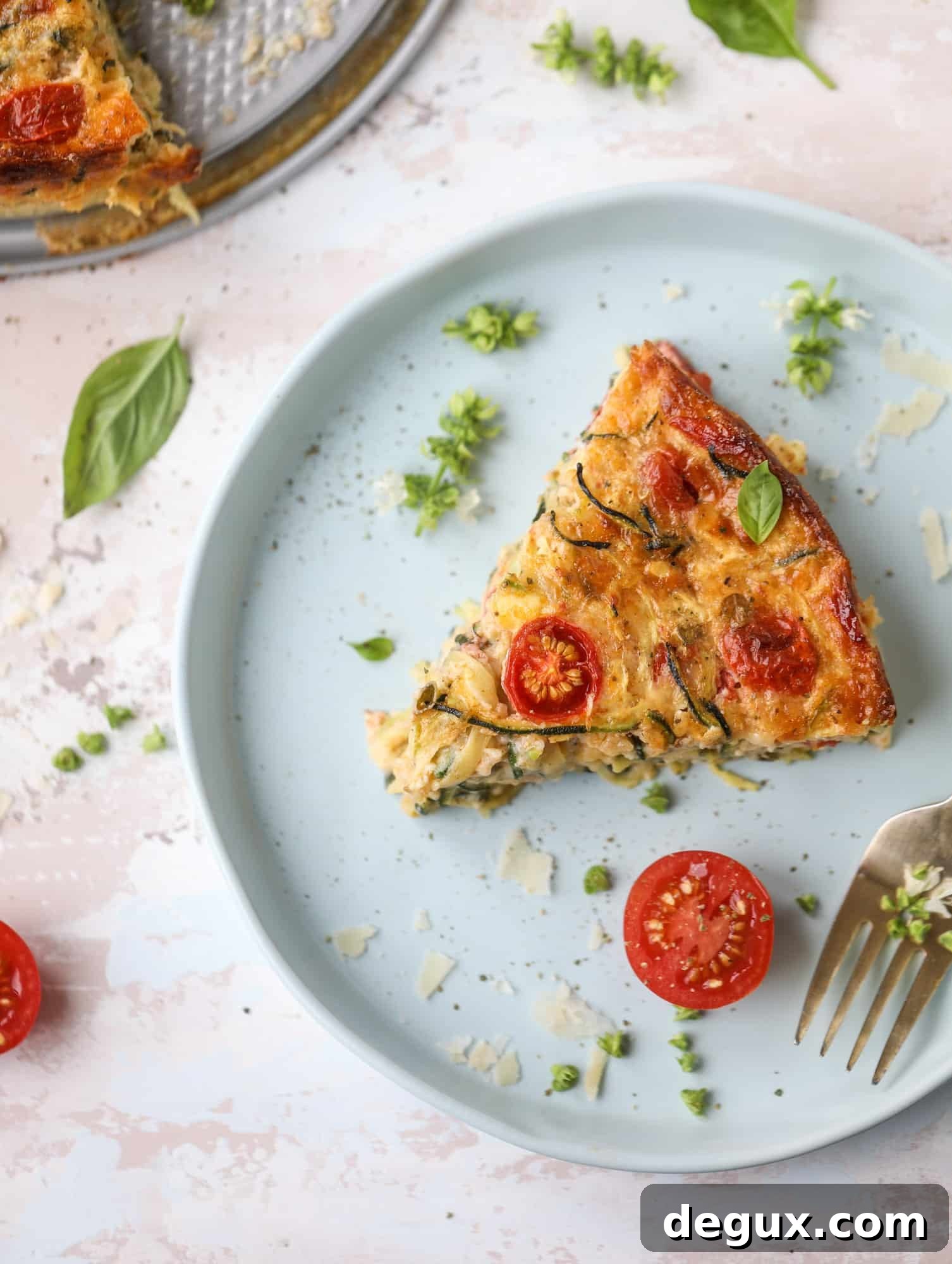 This zucchini pie recipes is absolutely divine and perfect for breakfast or dinner! Completely with garlic and blistered tomatoes, it combines cheese and egg to make a to-die-for frittata-like dish that can be eaten hot or cold! I howsweeteats.com #zucchini #pie #tomatoes #eggs #recipes #garden #summer