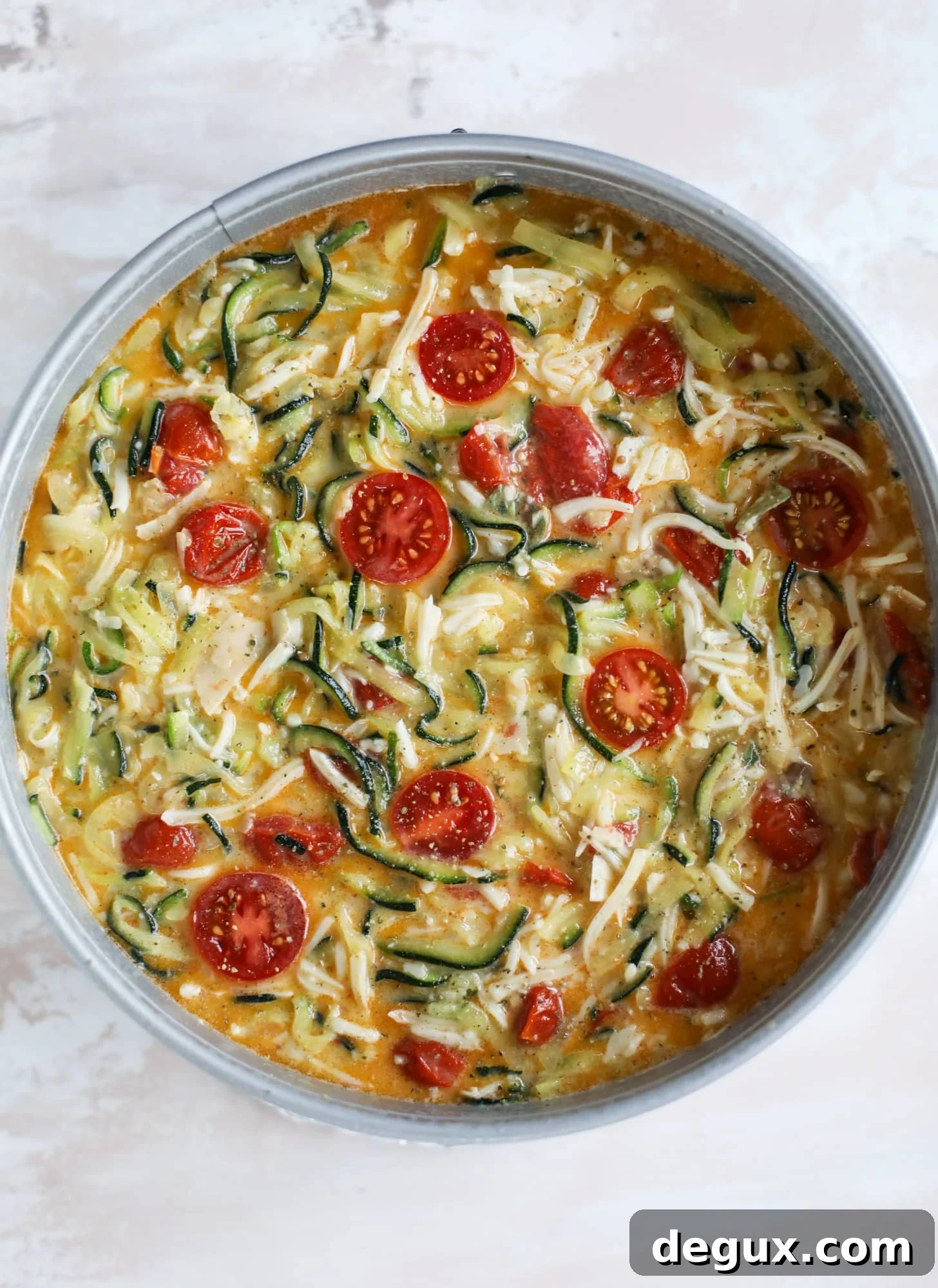 This zucchini pie recipes is absolutely divine and perfect for breakfast or dinner! Completely with garlic and blistered tomatoes, it combines cheese and egg to make a to-die-for frittata-like dish that can be eaten hot or cold! I howsweeteats.com #zucchini #pie #tomatoes #eggs #recipes #garden #summer