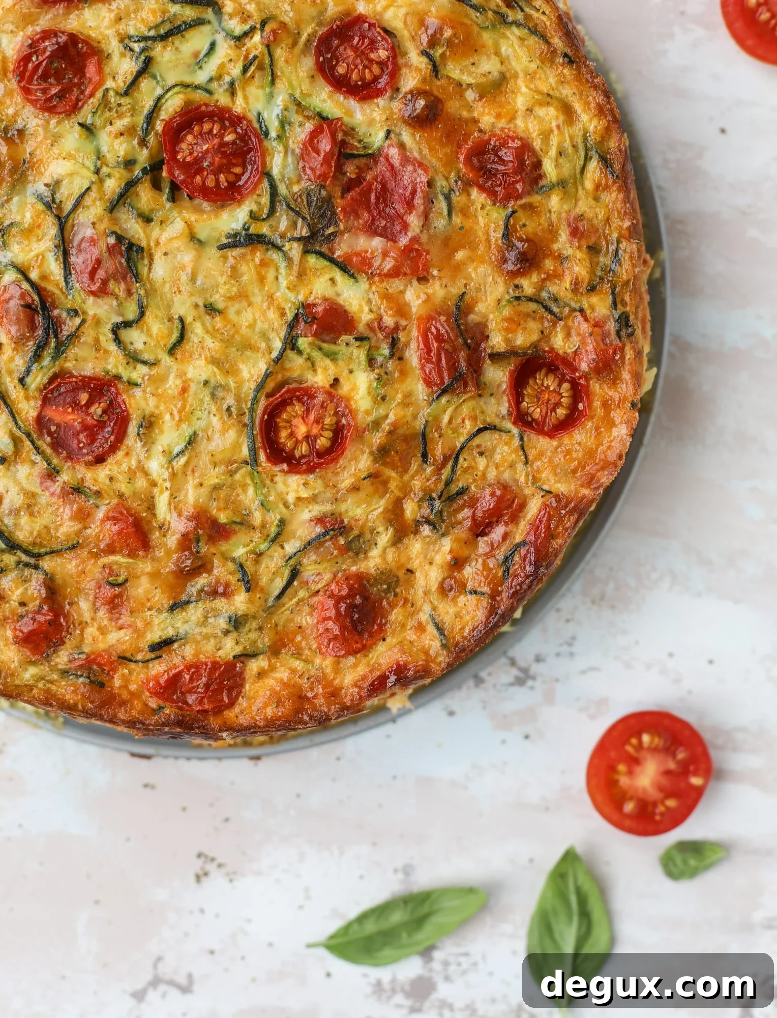 This zucchini pie recipes is absolutely divine and perfect for breakfast or dinner! Completely with garlic and blistered tomatoes, it combines cheese and egg to make a to-die-for frittata-like dish that can be eaten hot or cold! I howsweeteats.com #zucchini #pie #tomatoes #eggs #recipes #garden #summer