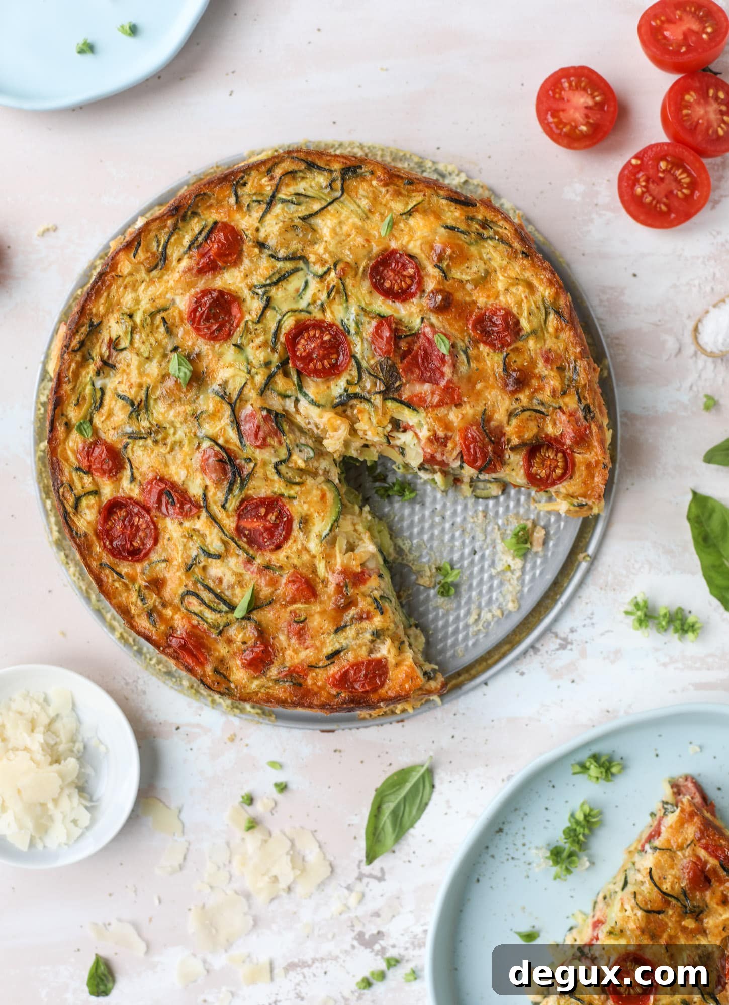 This zucchini pie recipes is absolutely divine and perfect for breakfast or dinner! Completely with garlic and blistered tomatoes, it combines cheese and egg to make a to-die-for frittata-like dish that can be eaten hot or cold! I howsweeteats.com #zucchini #pie #tomatoes #eggs #recipes #garden #summer